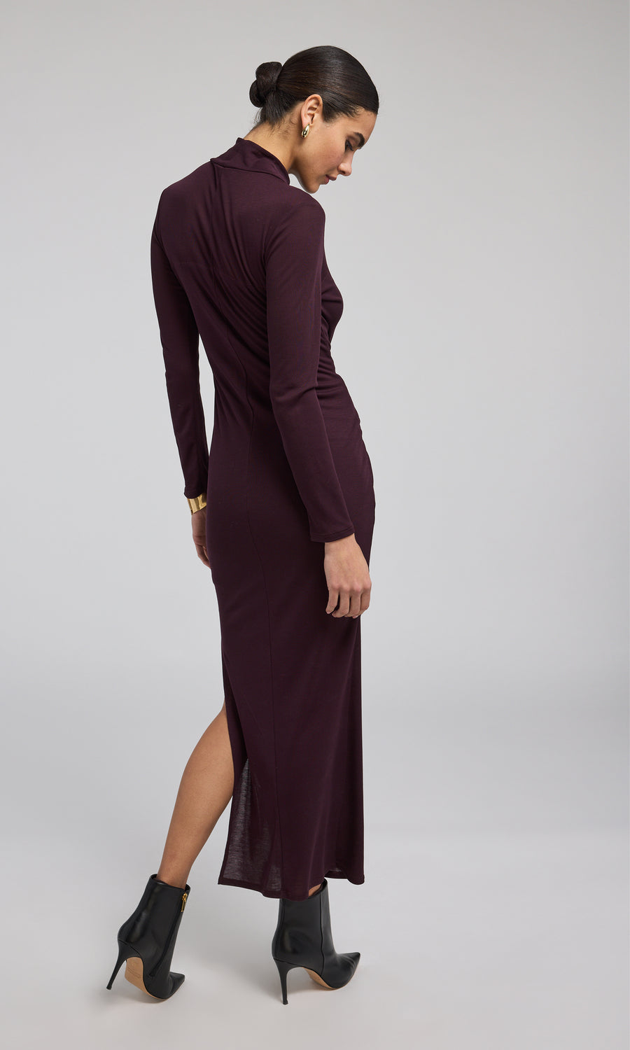 A long-sleeved long dress in a rich burgundy hue, elegantly designed for a sophisticated look.