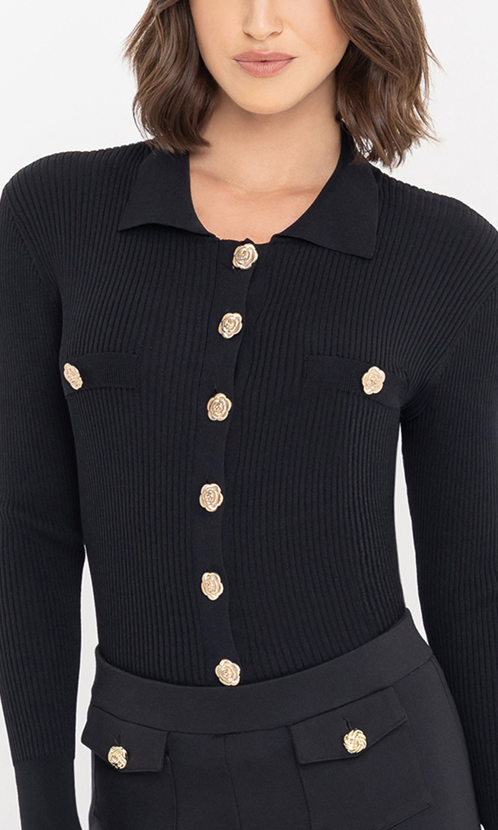 Close-up front view of the Carter Rib Cardigan in black, highlighting the ribbed texture and gold buttons.
