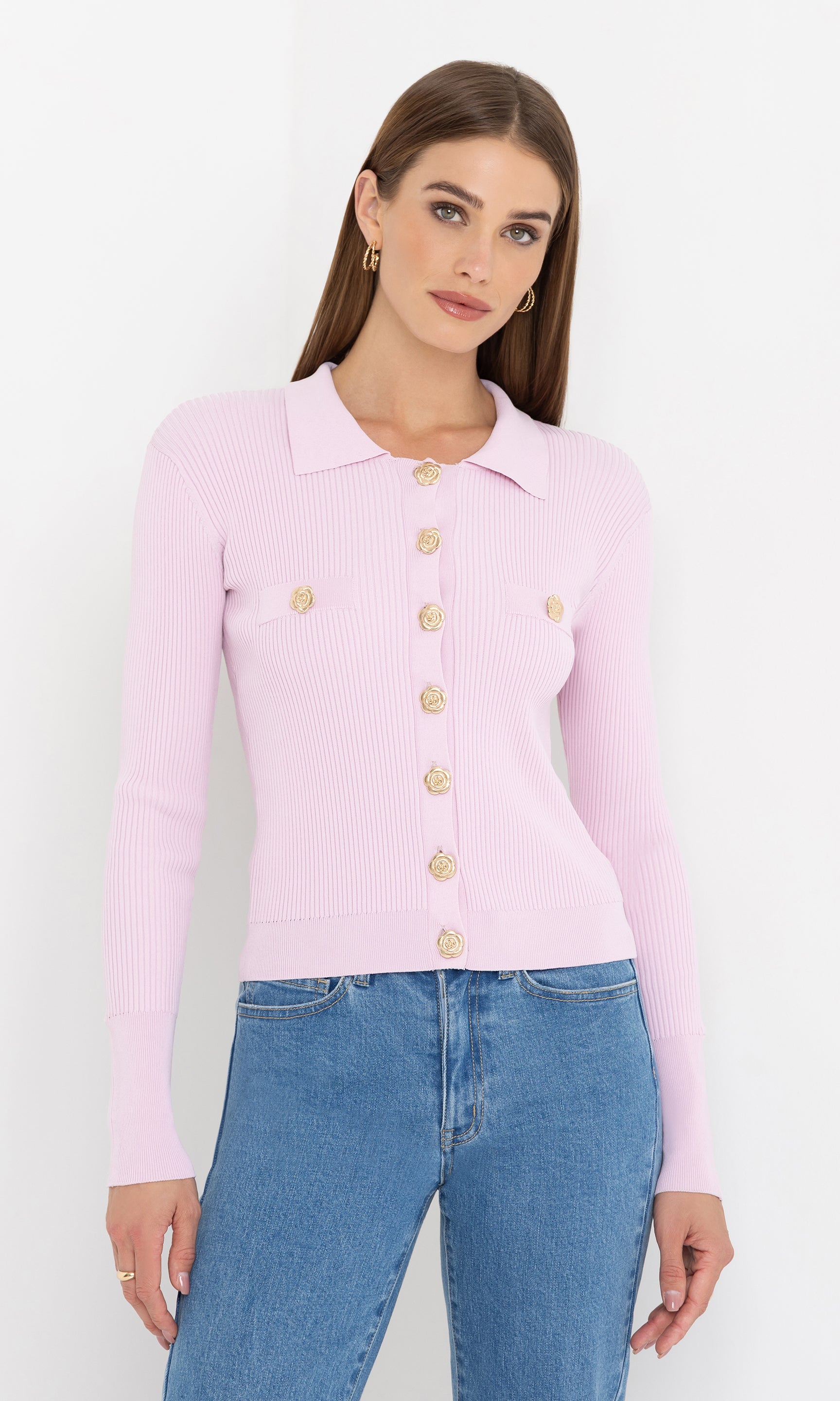 Front view of the Carter Rib Cardigan in light pink, paired with blue jeans and featuring gold button accents.