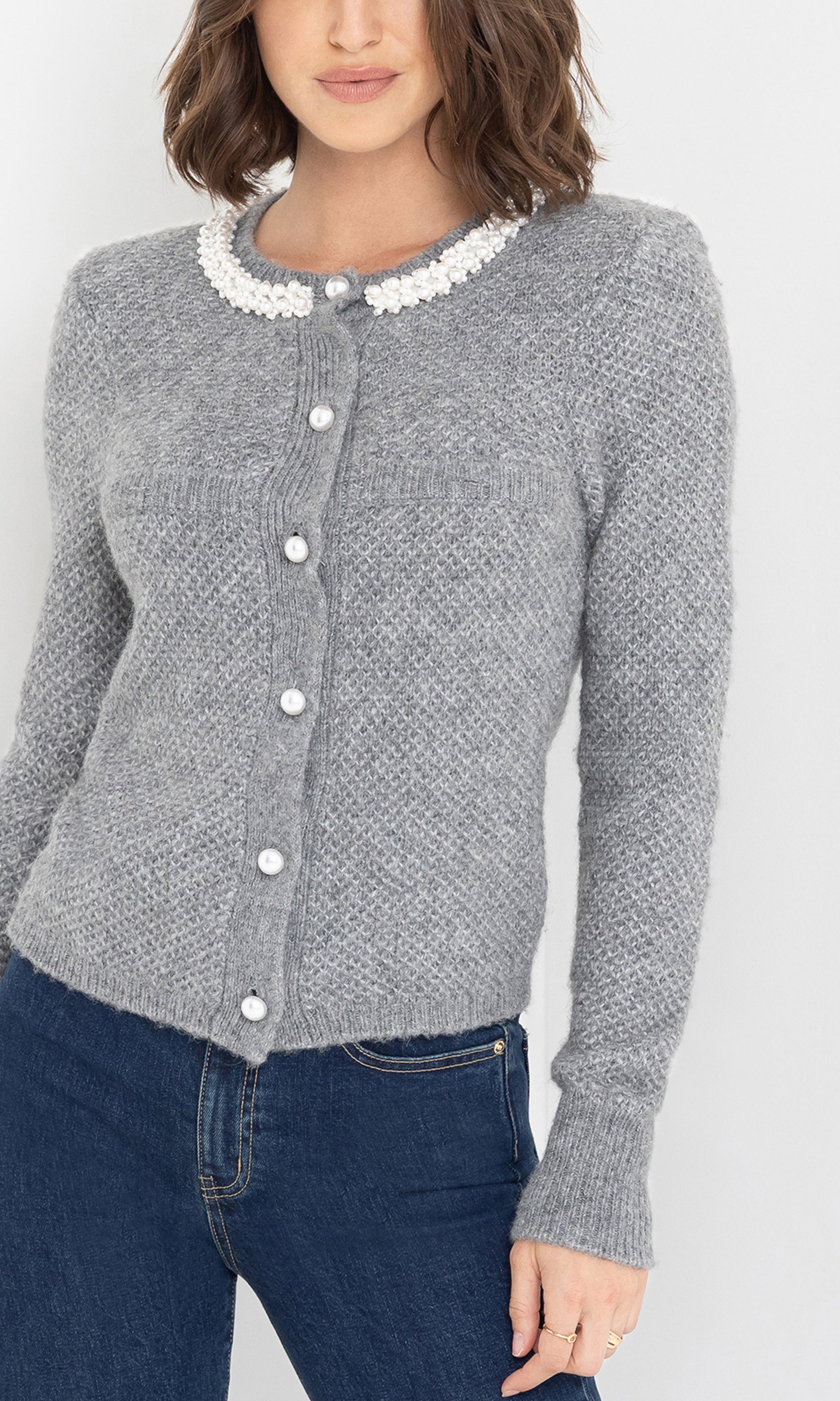 Close-up front view of the Clove Cardigan in grey, highlighting the white collar and textured knit details.