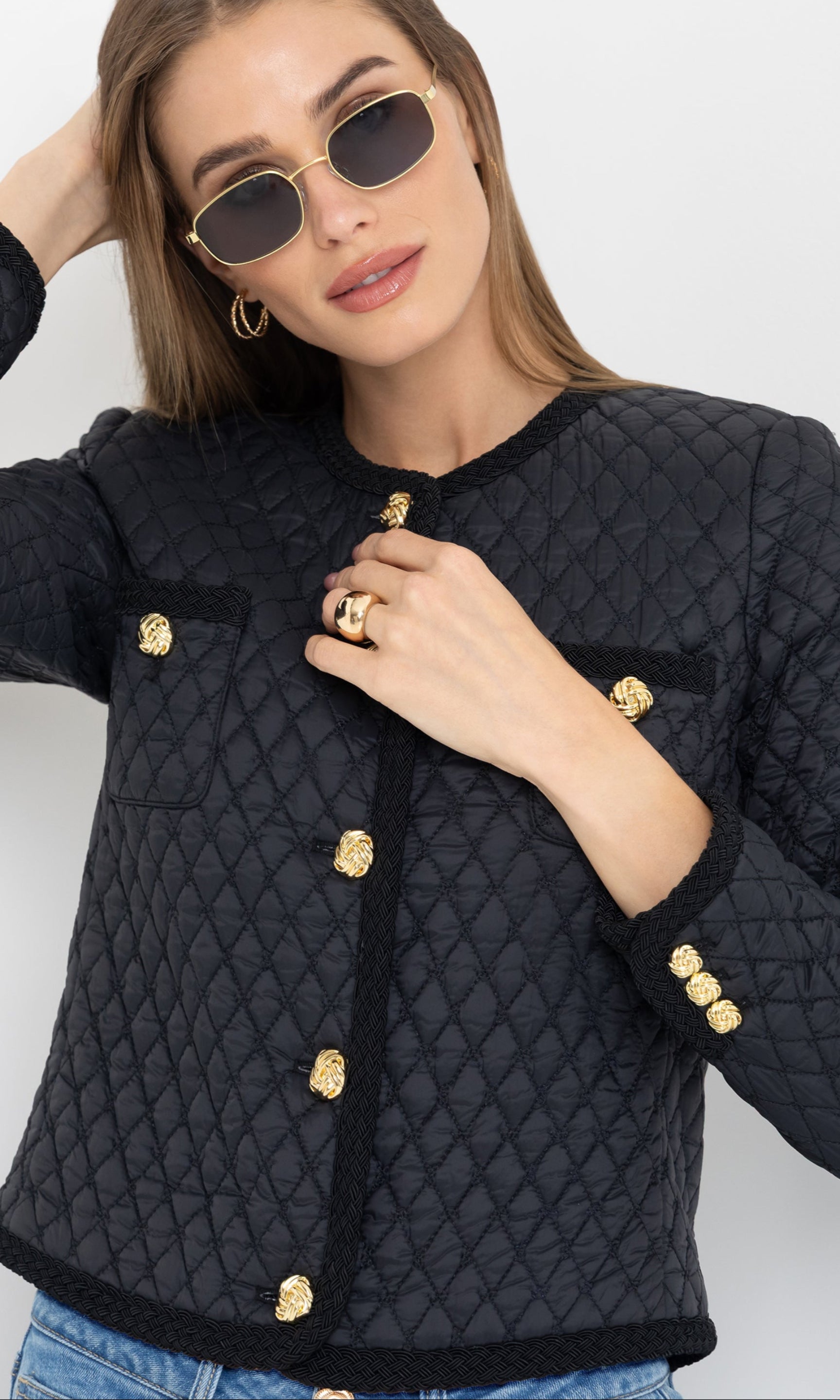Close-up front view showcasing the gold buttons and tailored silhouette of the black Everie Quilted Jacket.