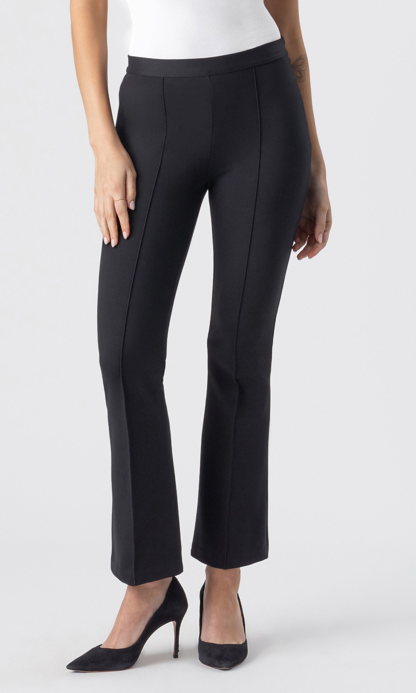 cropped image of model wearing the Fay Ponte Leggings in black paired with a white tank and black heels