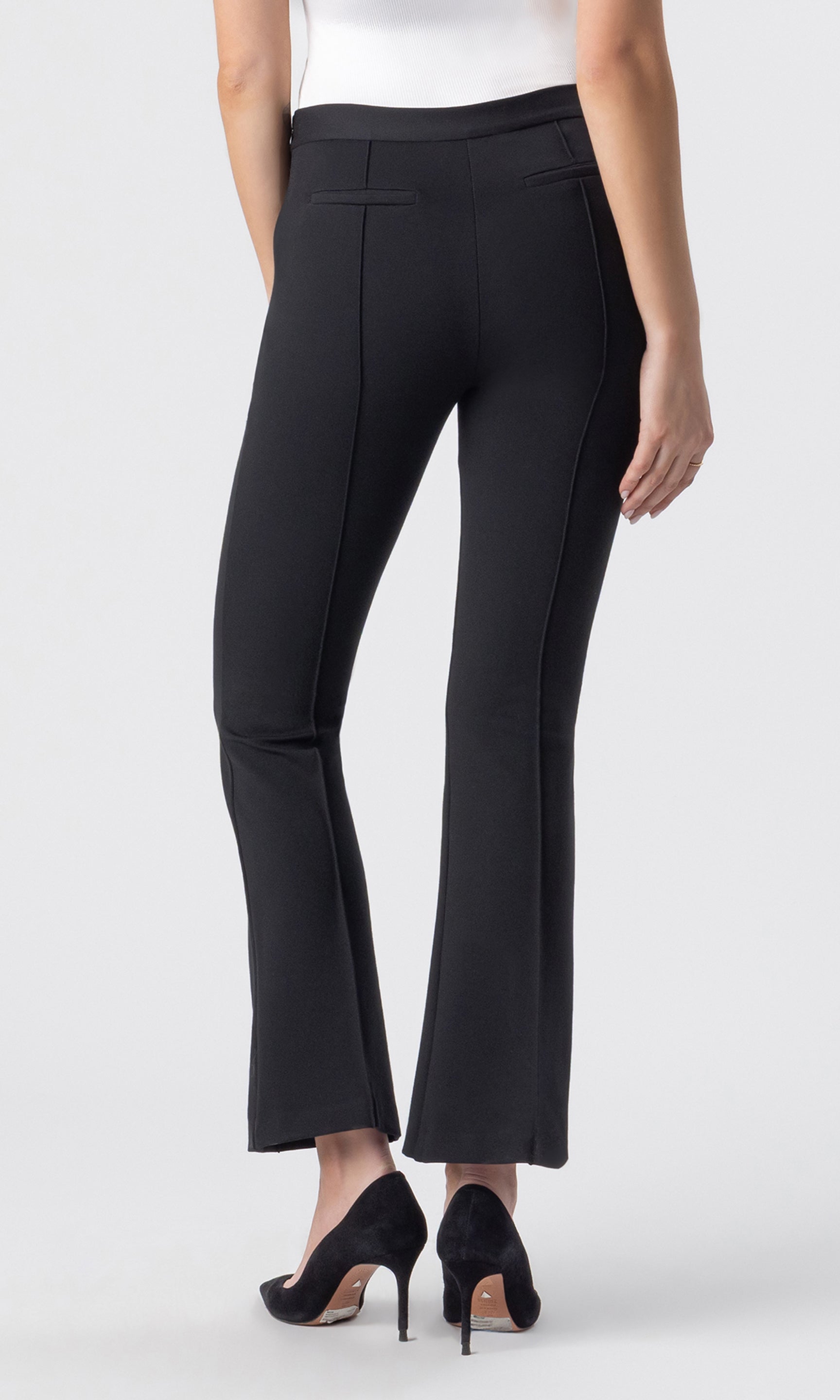 cropped back view image of model wearing the Fay Ponte Leggings in black paired with a white tank and black heels