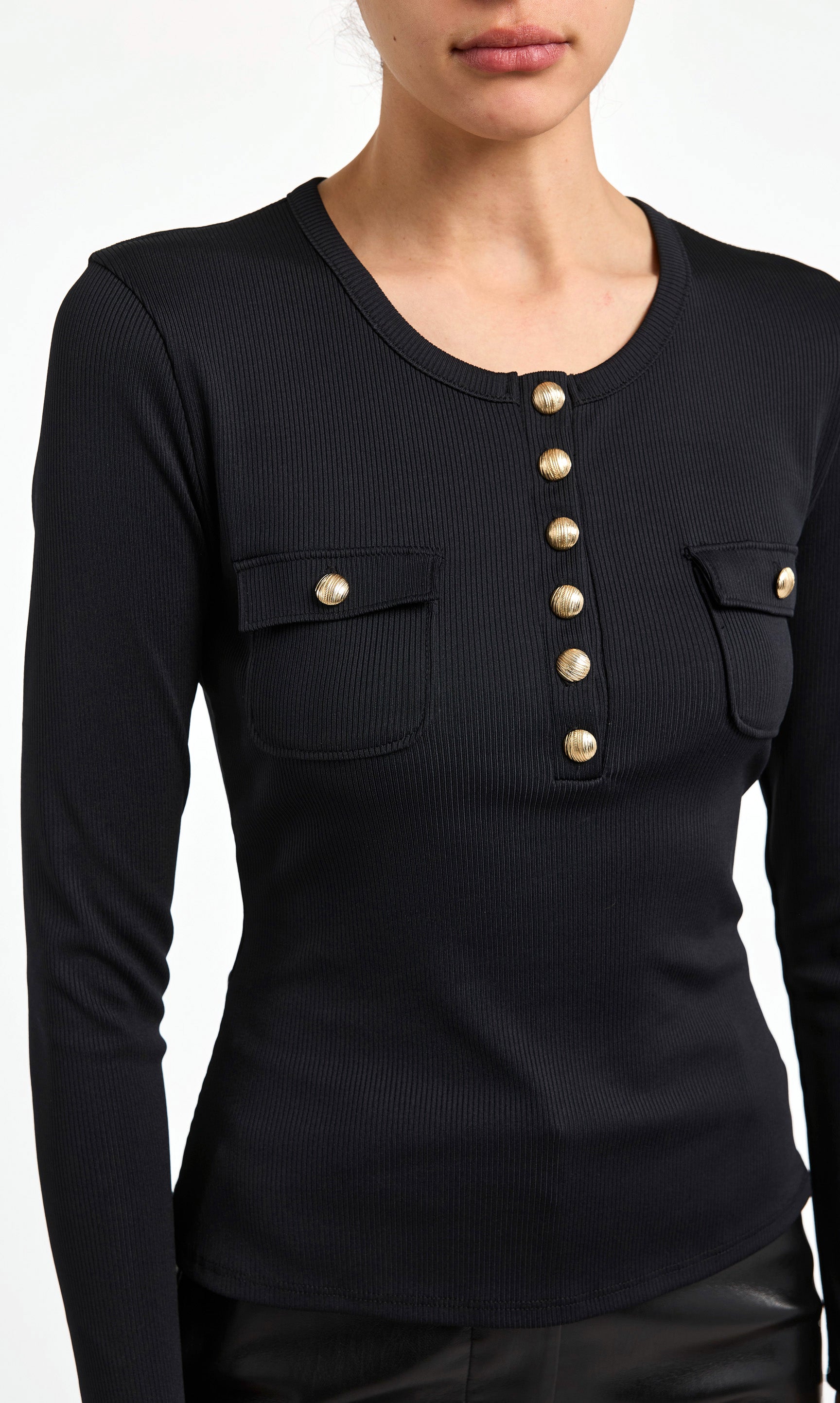 Black long-sleeve shirt with gold buttons and pockets on a white background