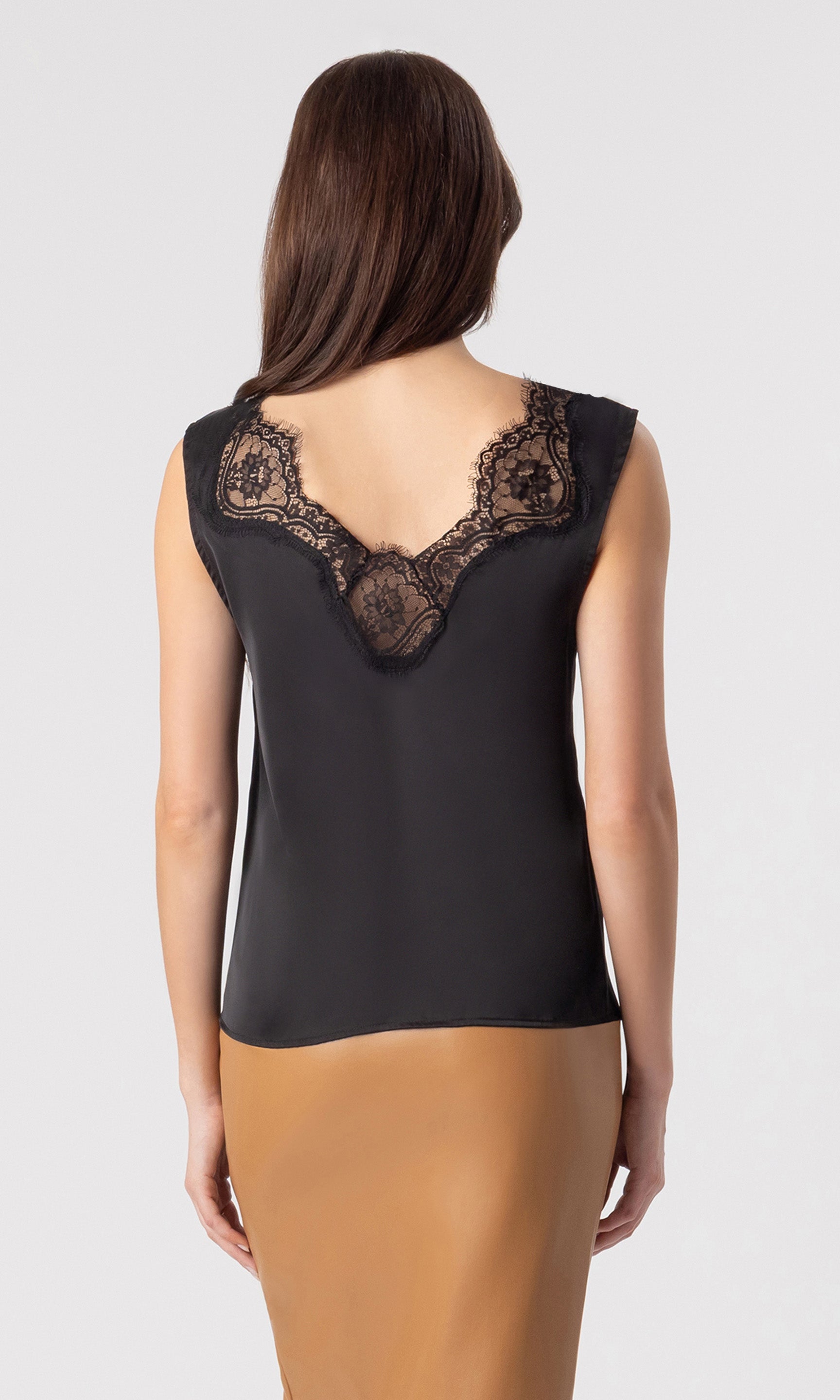 back view image of model wearing the Gladis tank in black paired with a light brown skirt