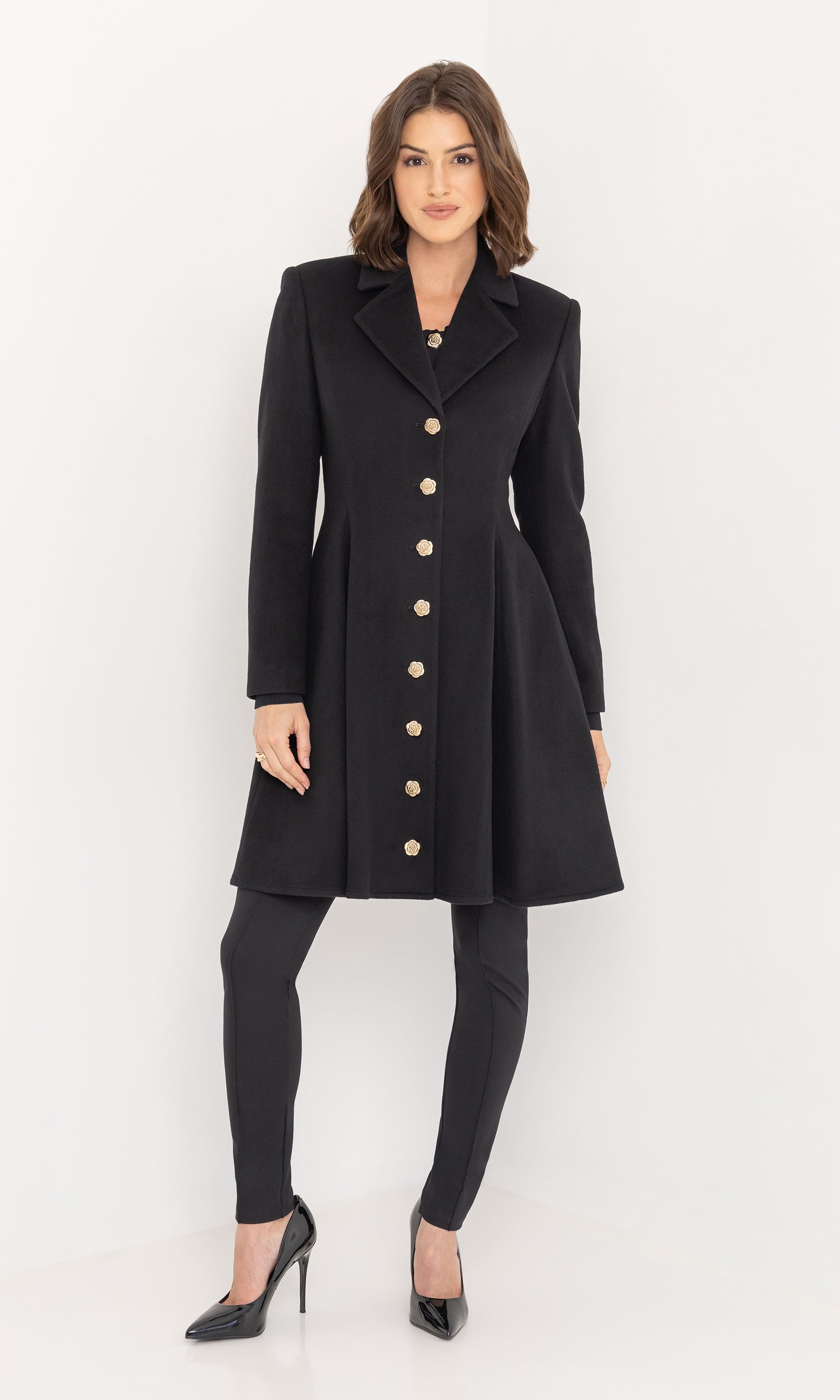 Front view of the Judy Wool Coat in classic black, styled with slim-fit pants and pointed heels for a refined look.