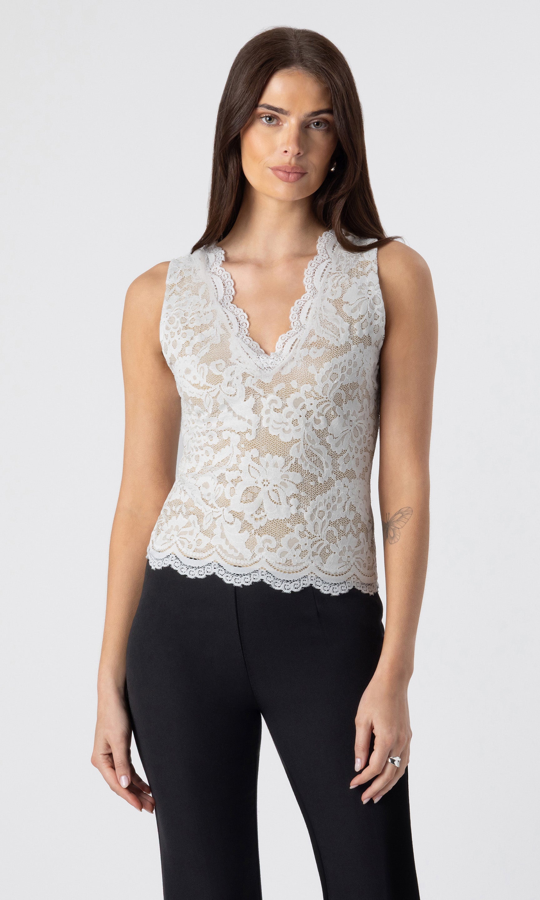 image of model wearing the Leila lace tank in white/beige paired with black crepe pants
