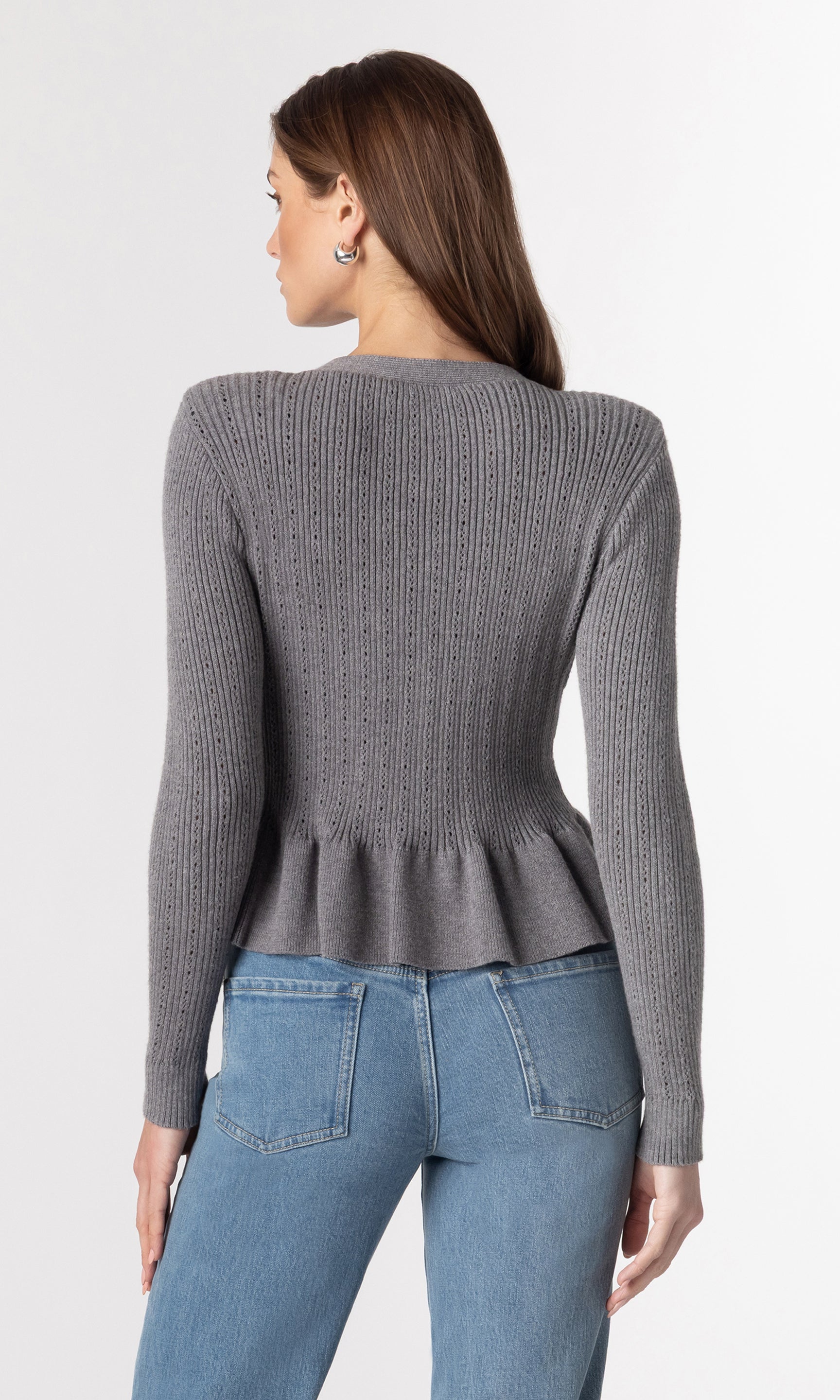 back view image of model wearing the Lirio Pointelle Cardigan in a grey color paired with blue jeans