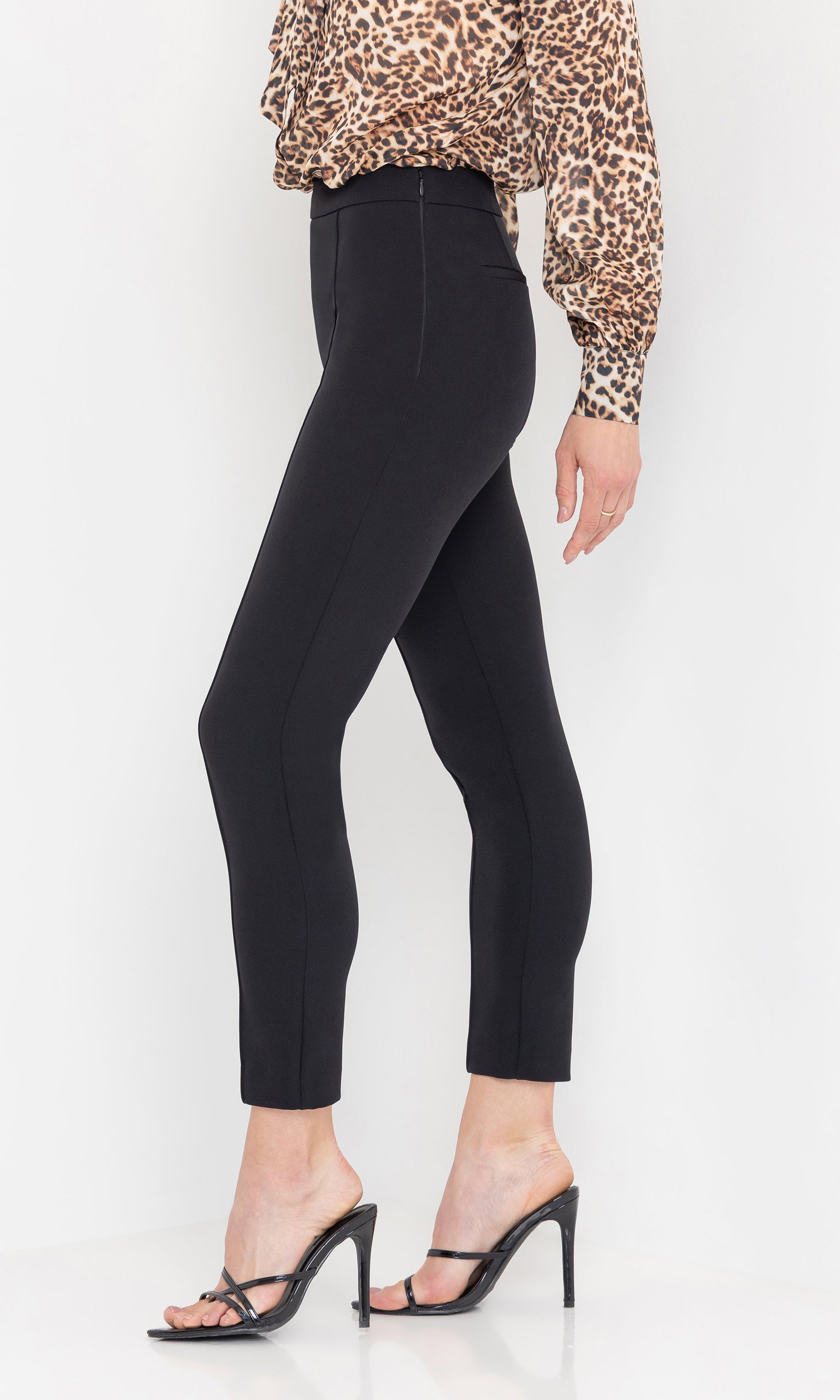 Side view of the Lonny Crepe Pants styled with a long-sleeve top and heels.