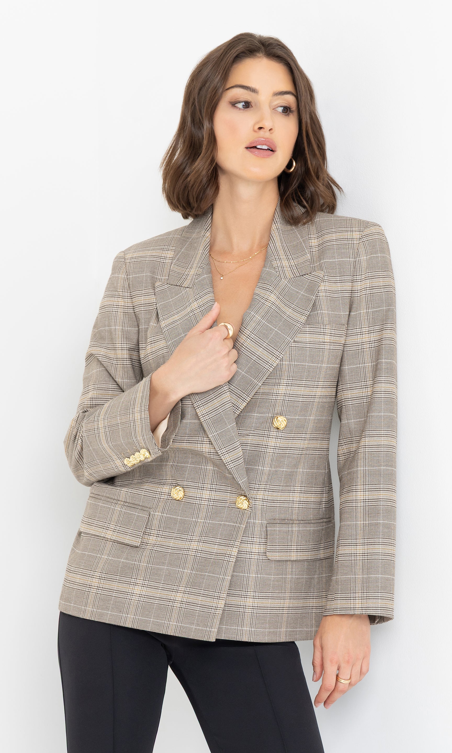 Three-quarter view of the blazer showing its clean lines and elegant plaid pattern.