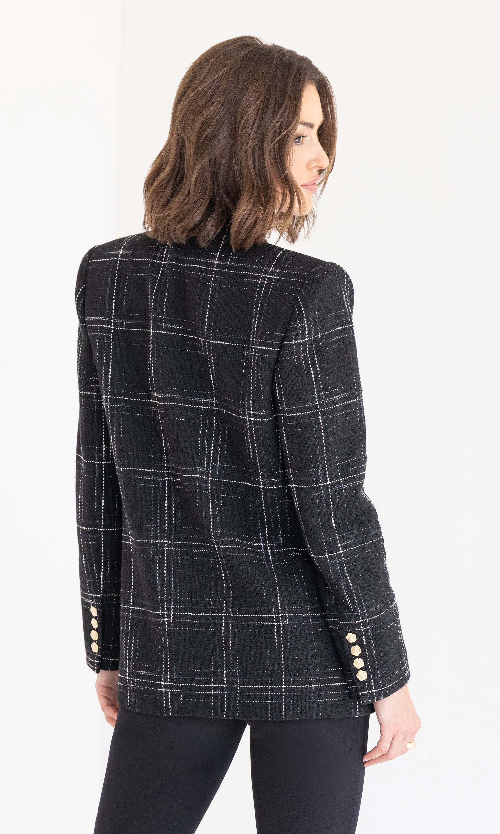 Rear view of the blazer showcasing the structured shoulders and windowpane pattern.