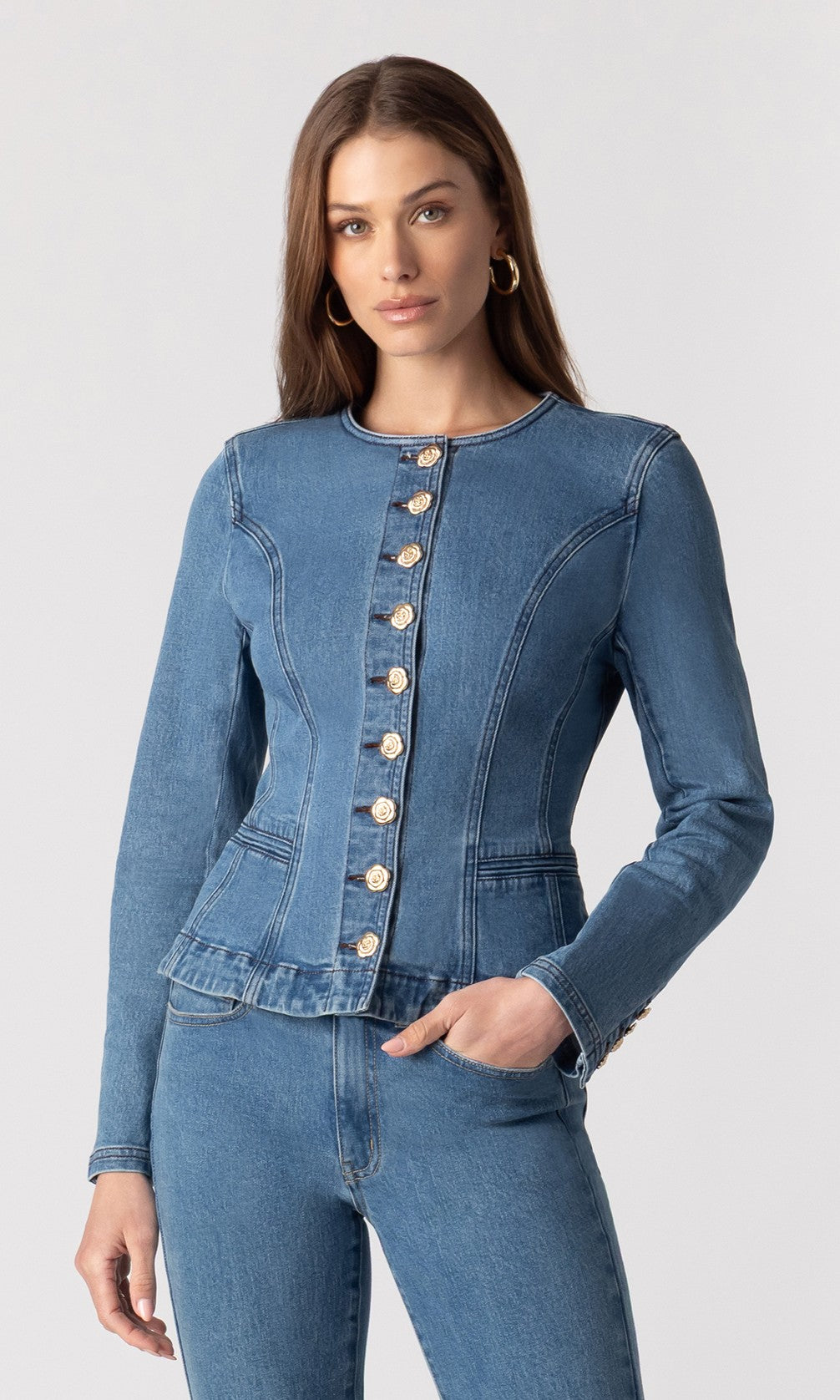 full body image of model wearing the Ophelia blue denim jacket paired with matching blue denim jeans and beige heels