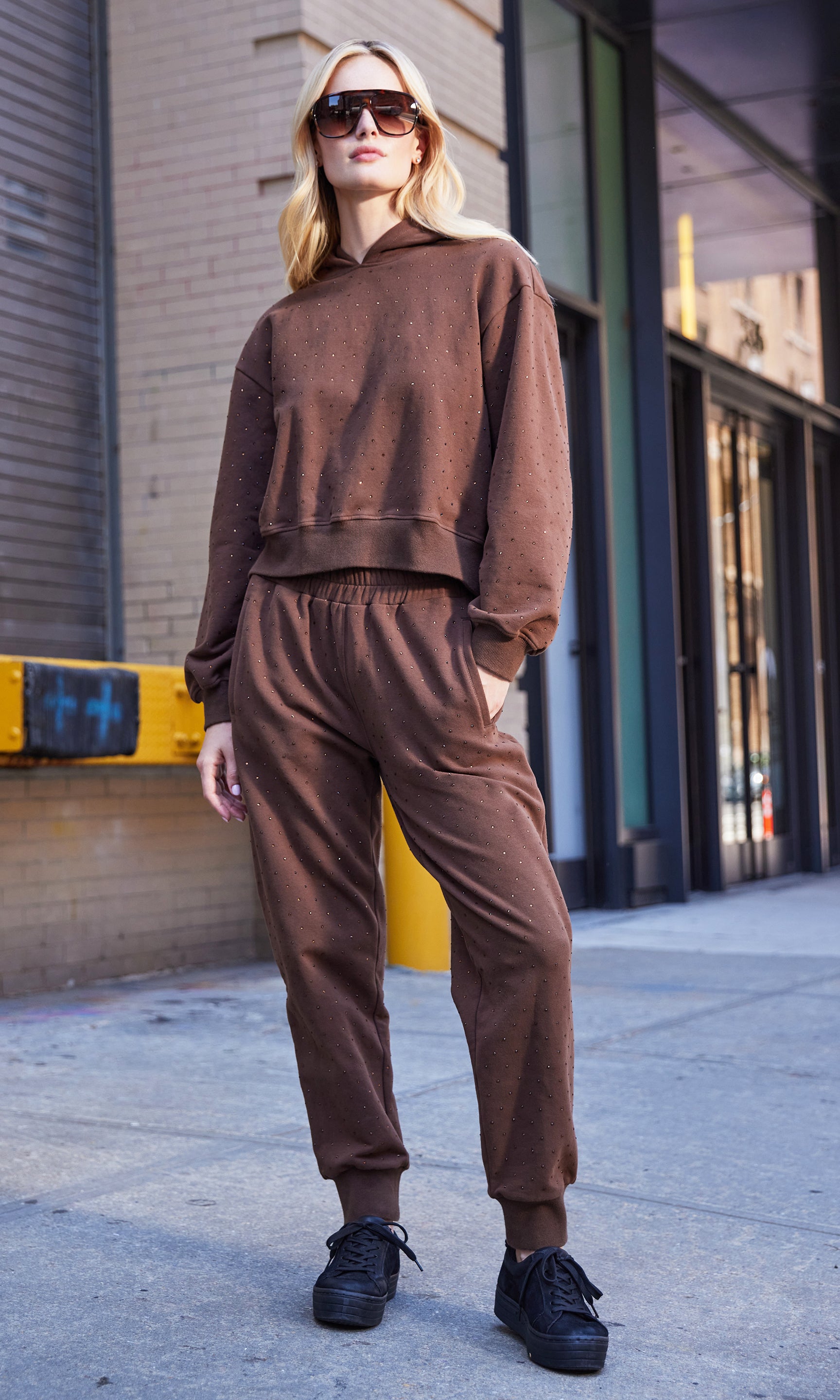 Full body front view of the model in the ruel crystal sweatpants styled with the matching hoodie.
