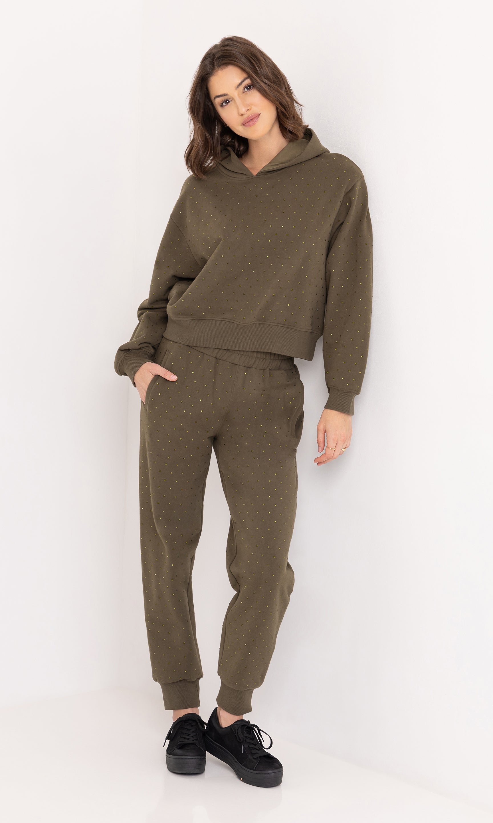Full body front view of the Ruel Crystal Sweatpants paired with a matching sweatshirt and black sneakers.