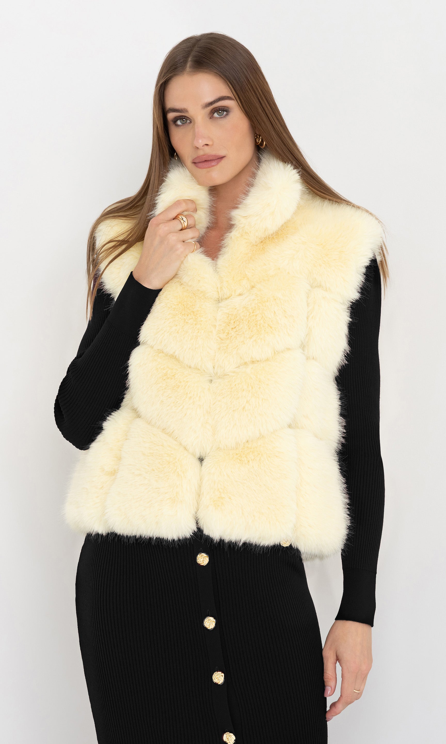 Front view of Rosario Faux Fur Vest in cream, paired with a burgundy long-sleeve dress for a chic winter look.