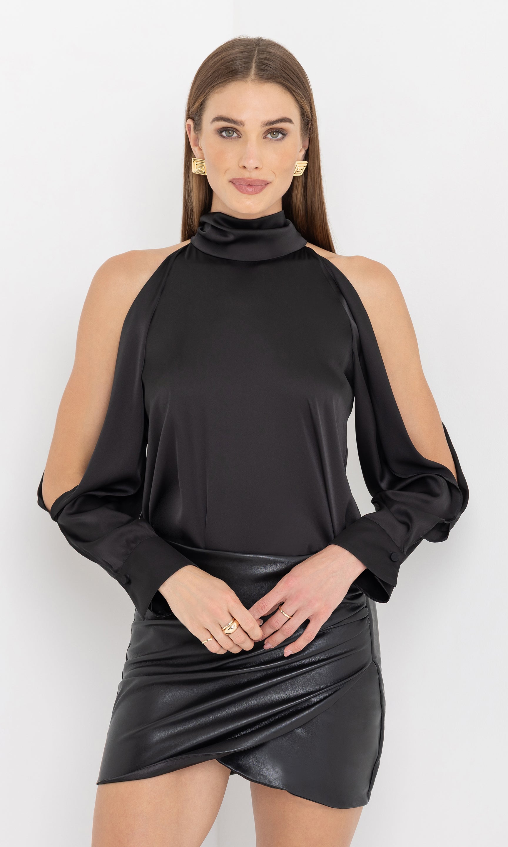 Front view of Rossi Halter Blouse in black, featuring open shoulders and a relaxed fit, paired with a black mini skirt.