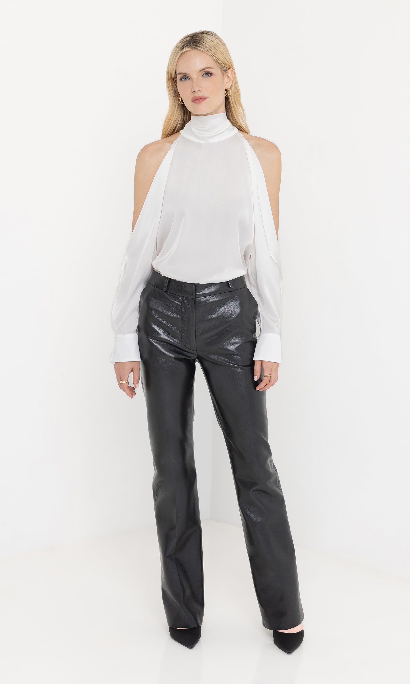 Full body front view of Rossi Halter Blouse in white, styled with black leather pants and heels.