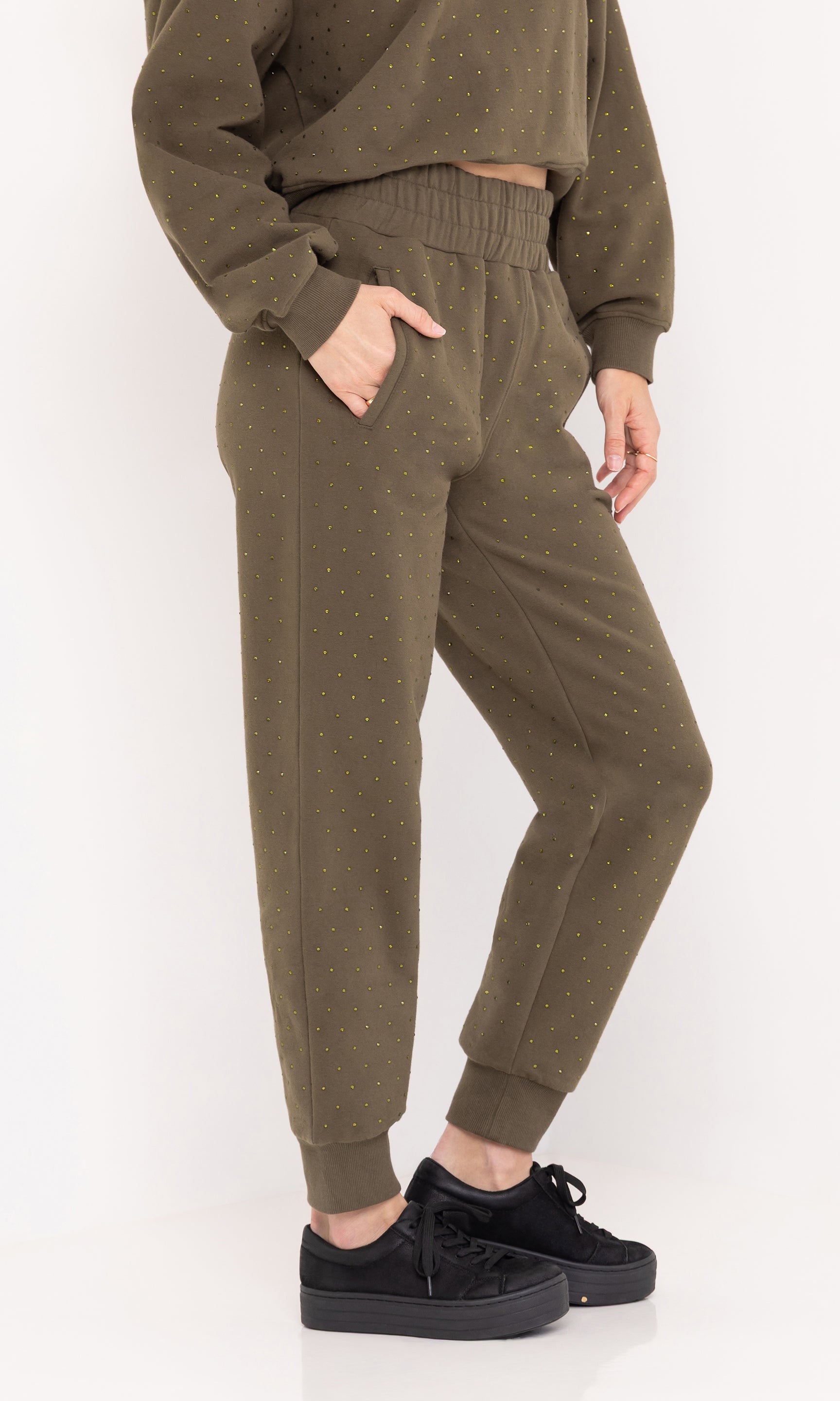 Side view of the Ruel Crystal Sweatpants in olive, showing the tapered leg and elastic cuff.