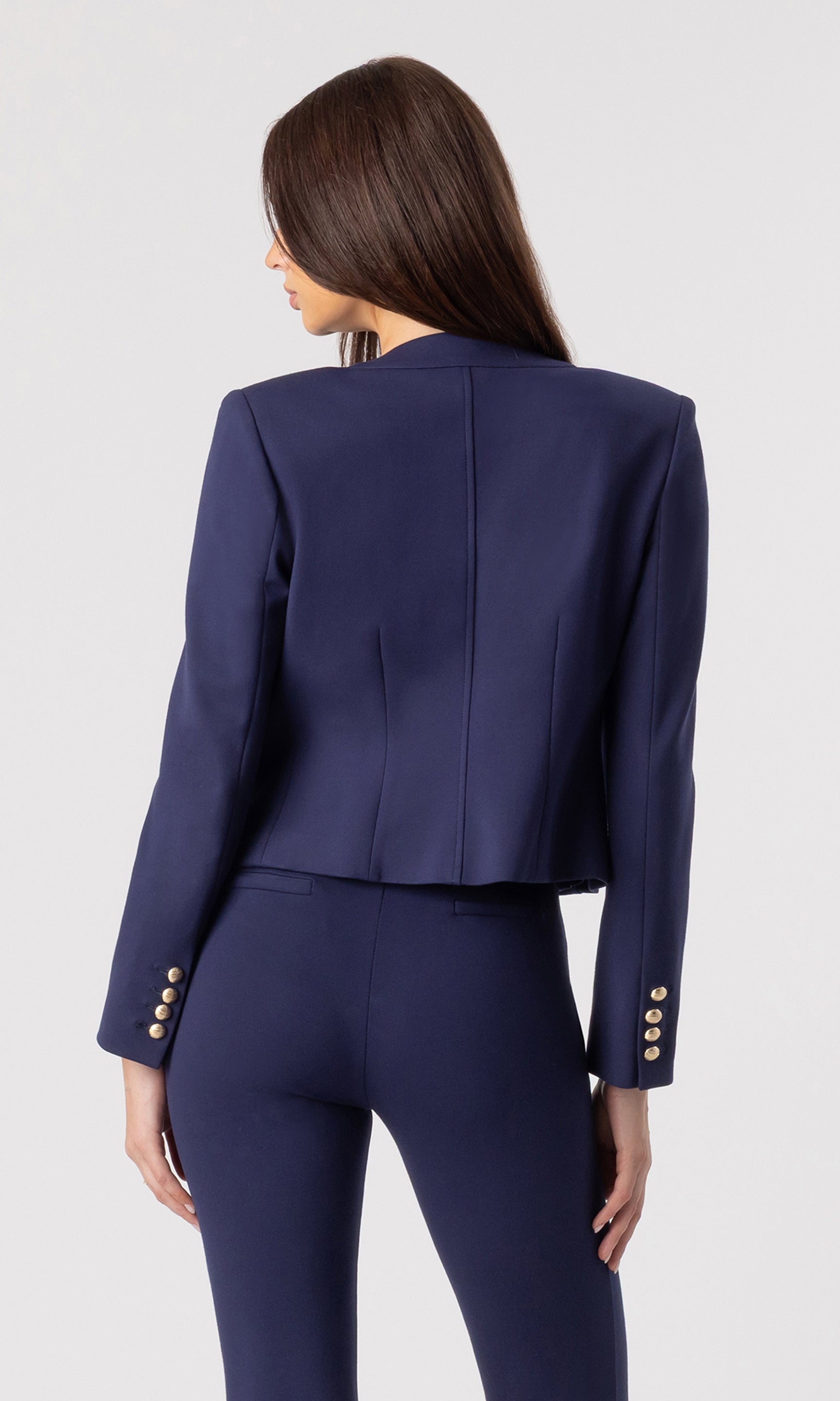 back view image of model wearing the Siena Ponte Jacket in navy over a navy/beige tank bodysuit and paired with navy leggings