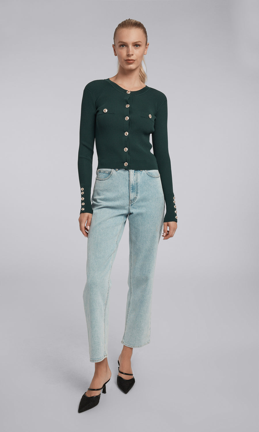 A cropped green rib cardigan adorned with gold buttons, highlighting a chic and fashionable look.