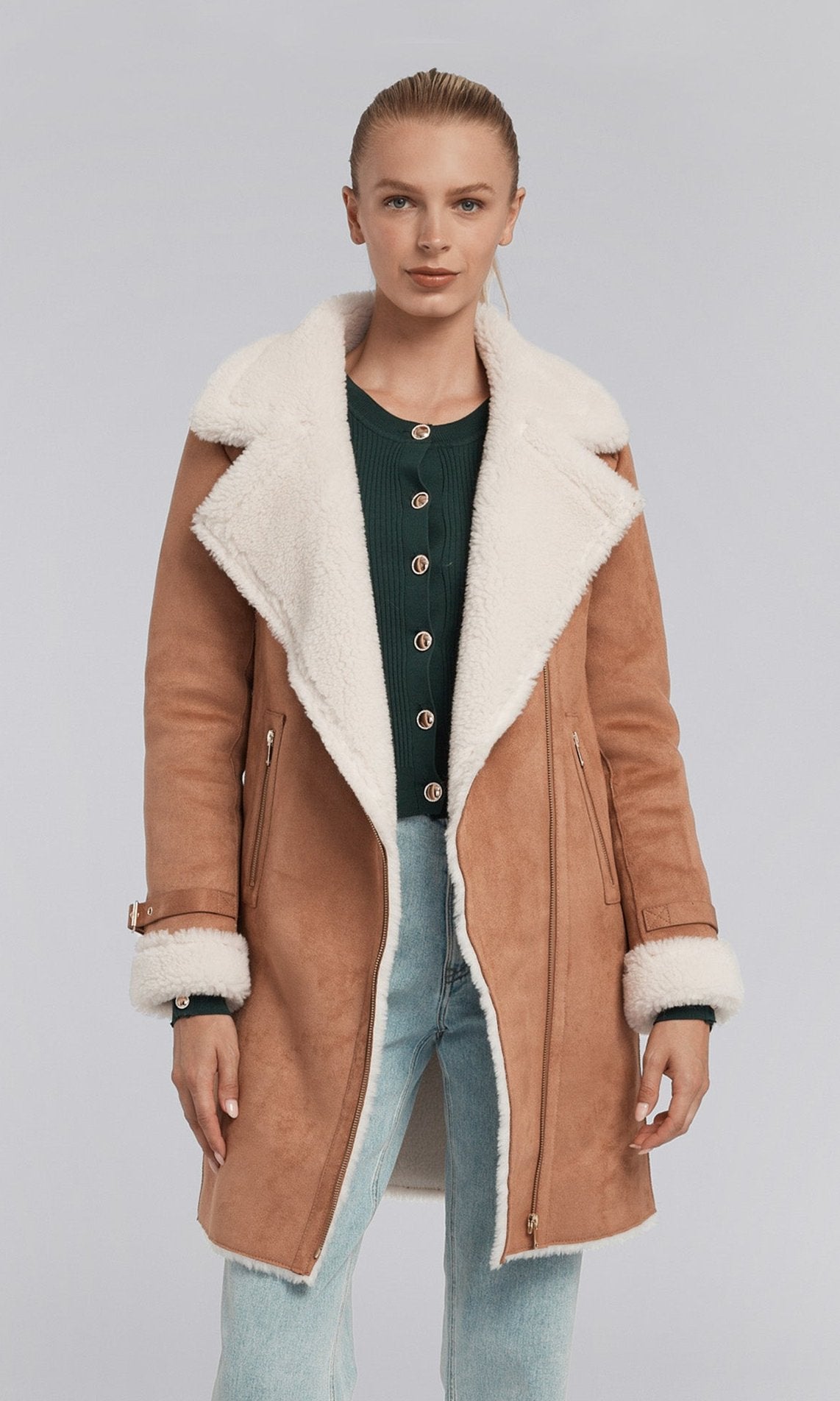 The image features a model in a chic brown coat made of suede, adorned with a soft faux fur shearling collar for added comfort.