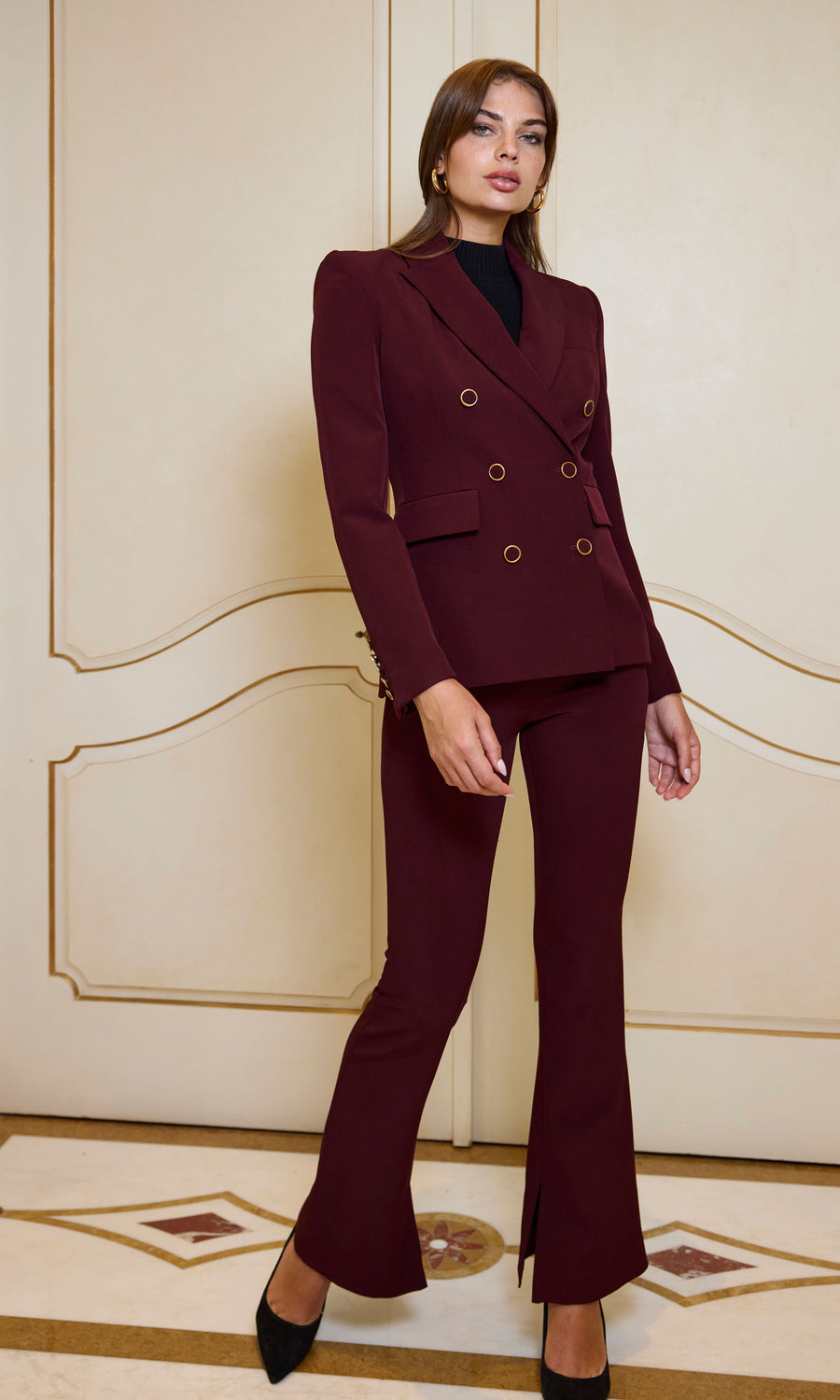 The image features a woman in chic burgundy Malbec crepe pants, highlighting her fashionable attire.