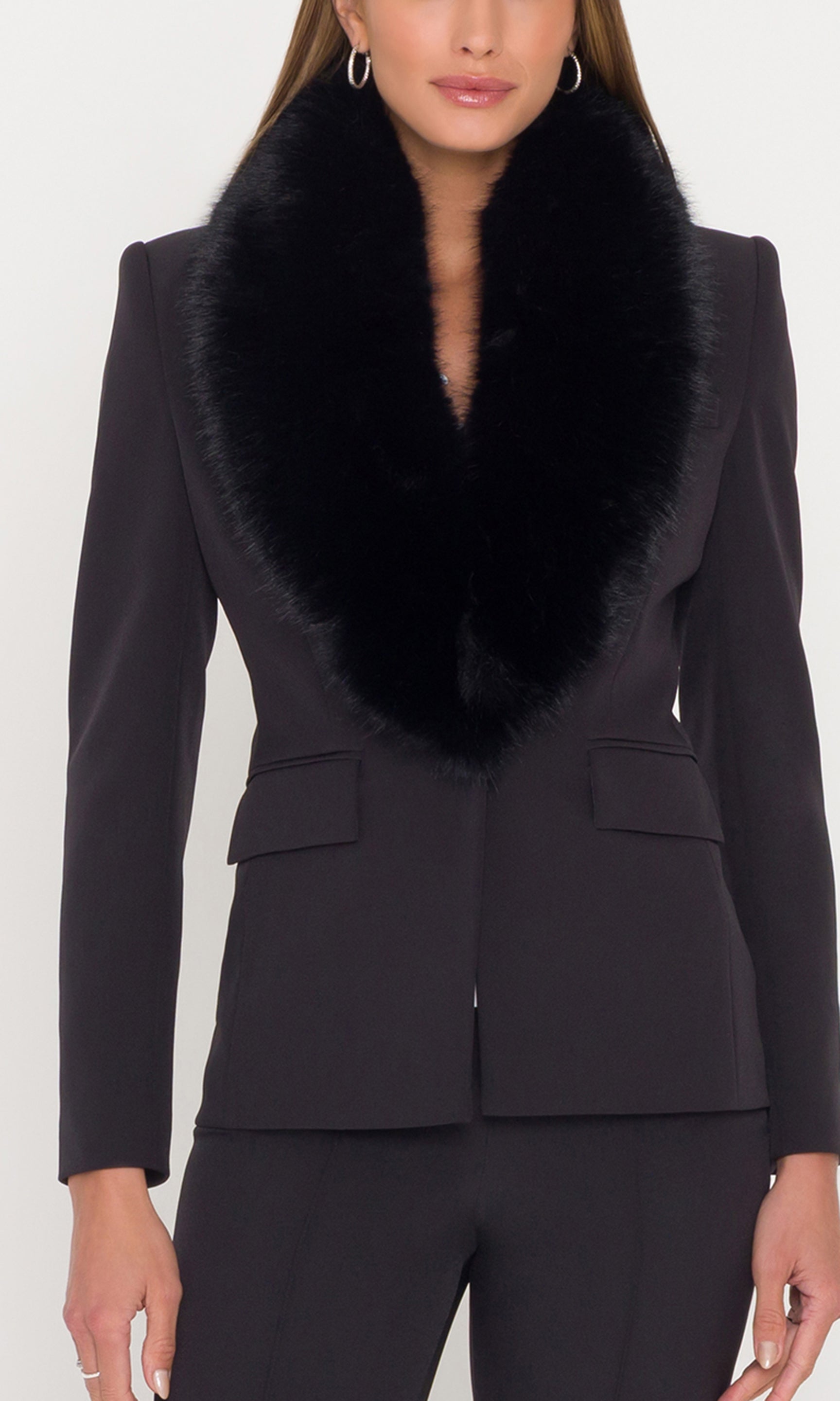 Close-up of crepe blazer with a fur collar on a white background