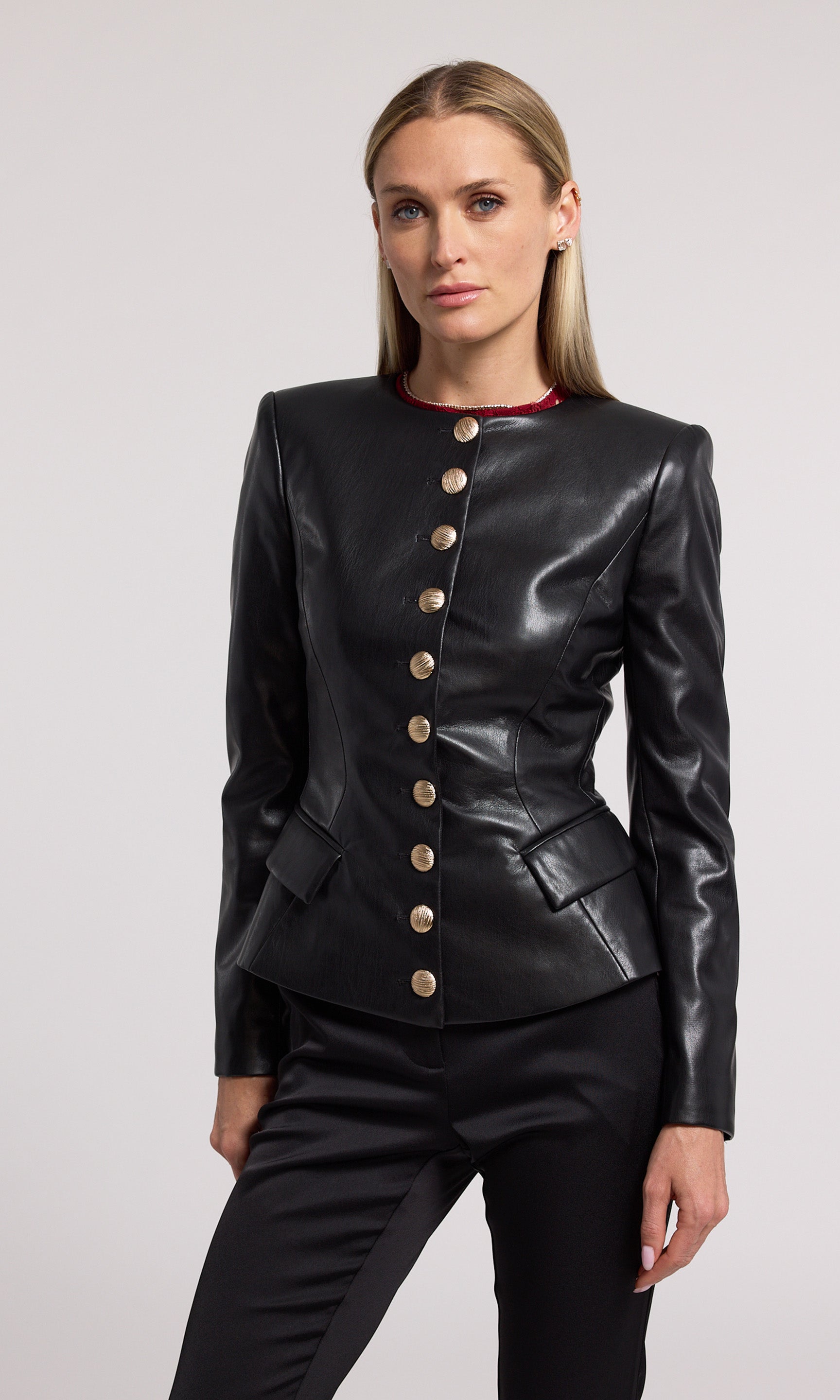 A stylish black vegan leather jacket made from soft, stretchy fabric, emphasizing comfort and contemporary fashion.