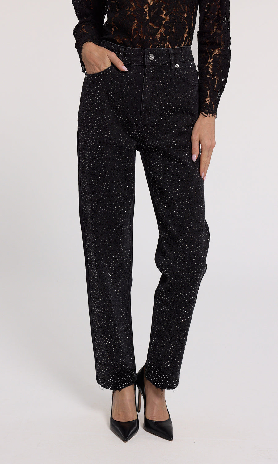 A close-up of black jeans featuring crystal embellishments, showcasing a stylish and elegant design.