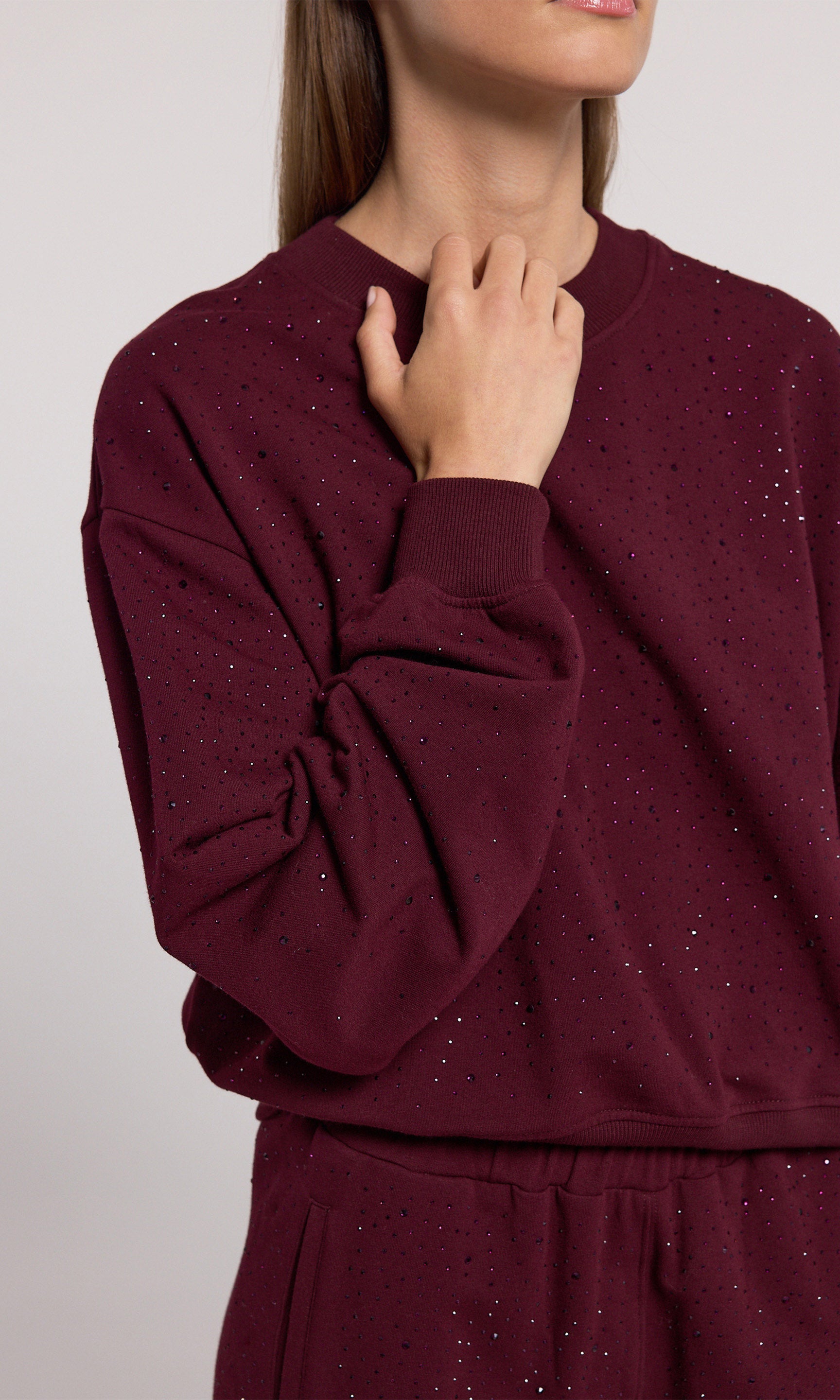 A black cherry sweatshirt crafted from soft with crystal and a stretchy fabric, showcasing comfort and style in a rich color.