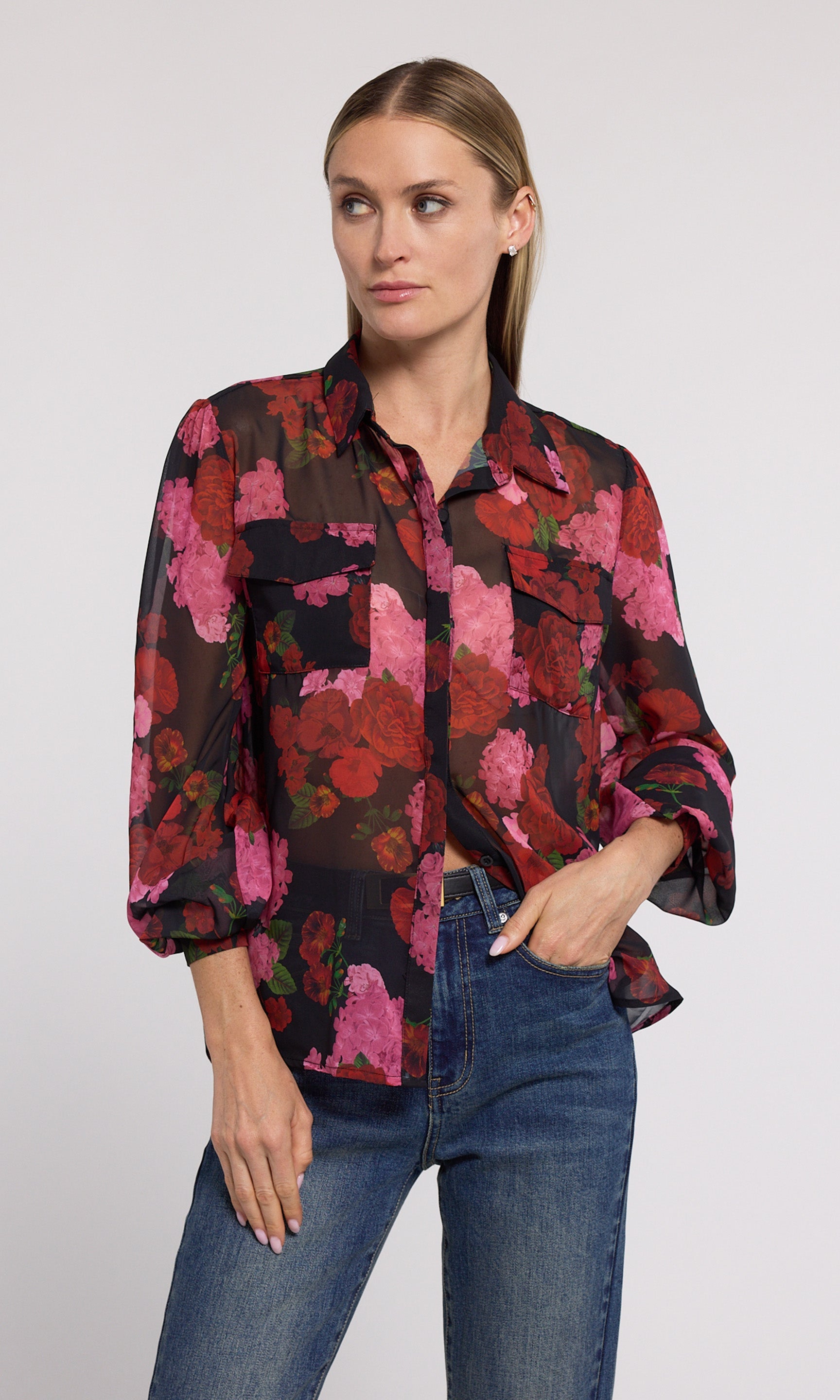 The image features a model in a black and pink floral shirt, adorned with striking floral designs that enhance its appeal.