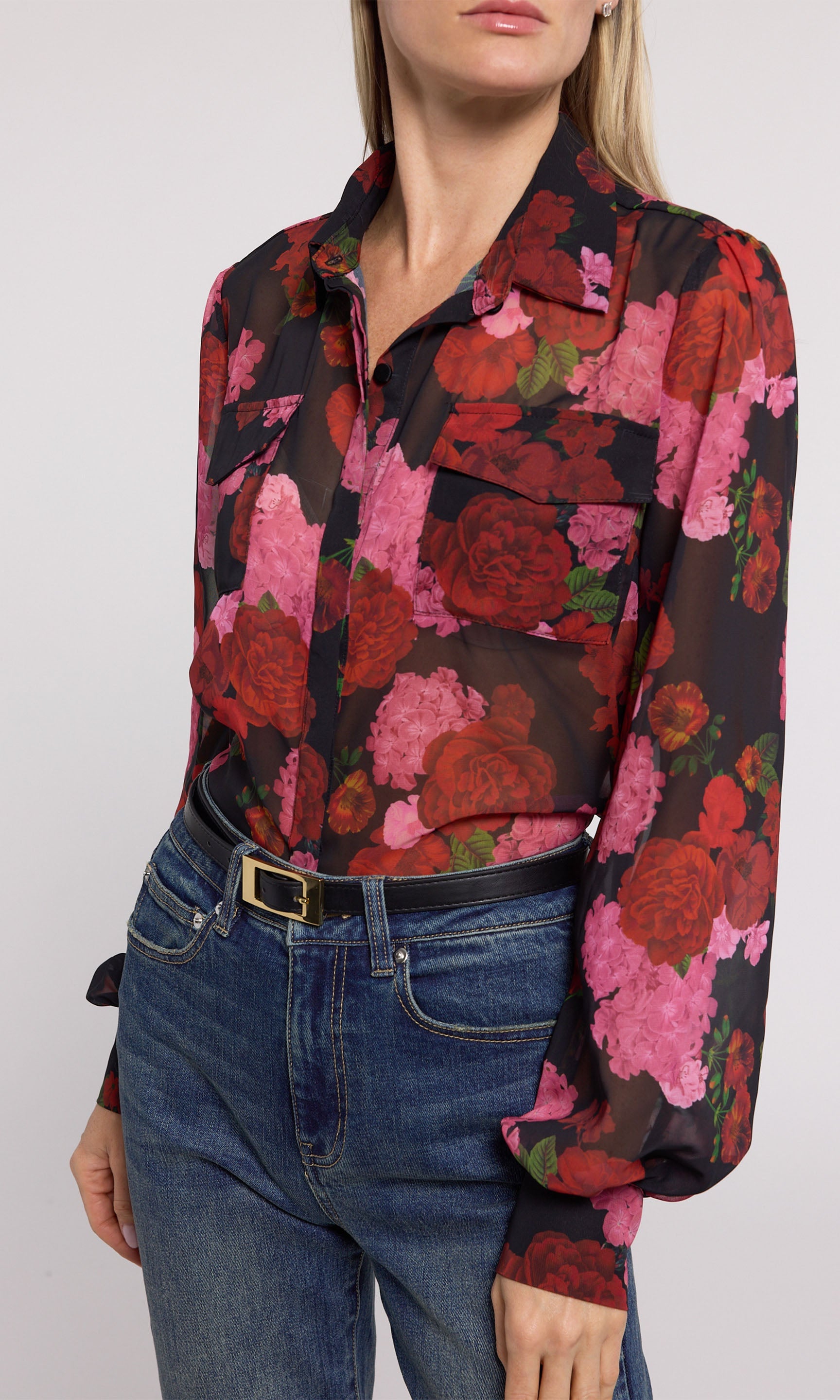 The image features a model in a black and pink floral shirt, adorned with striking floral designs that enhance its appeal.