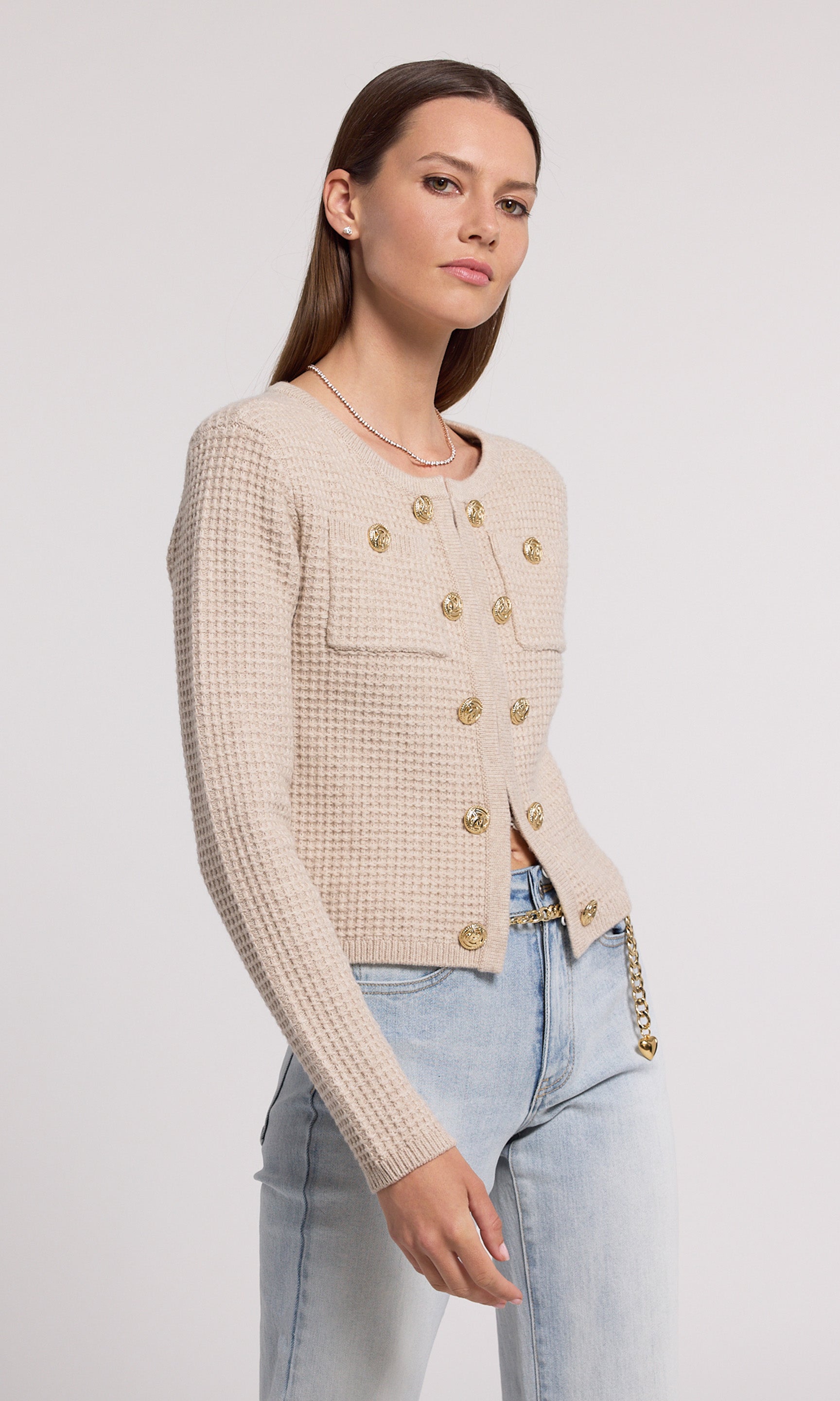 A soft knit cardigan in beige, offering comfort and elegance, suitable for various casual outfits.