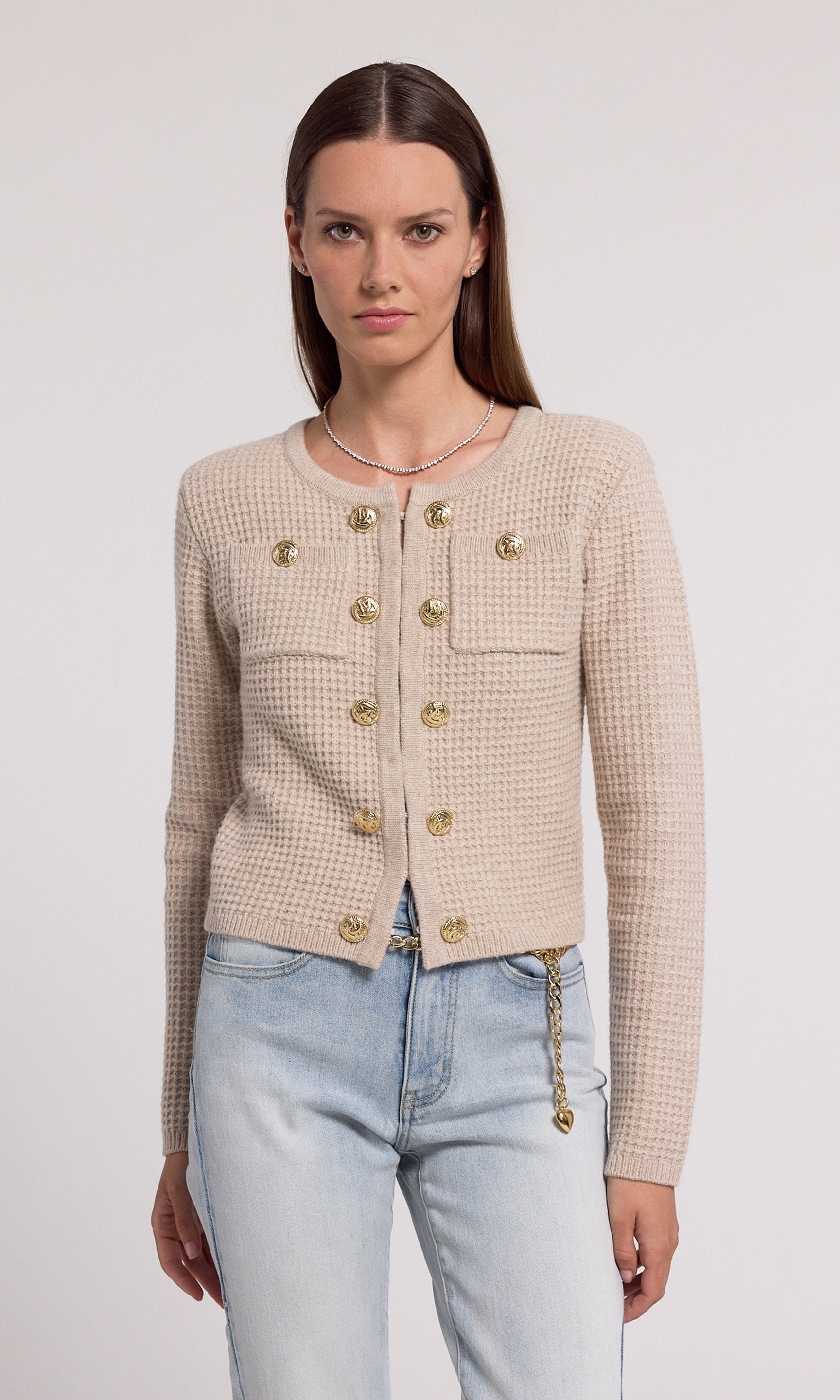 A soft knit cardigan in beige, offering comfort and elegance, suitable for various casual outfits.