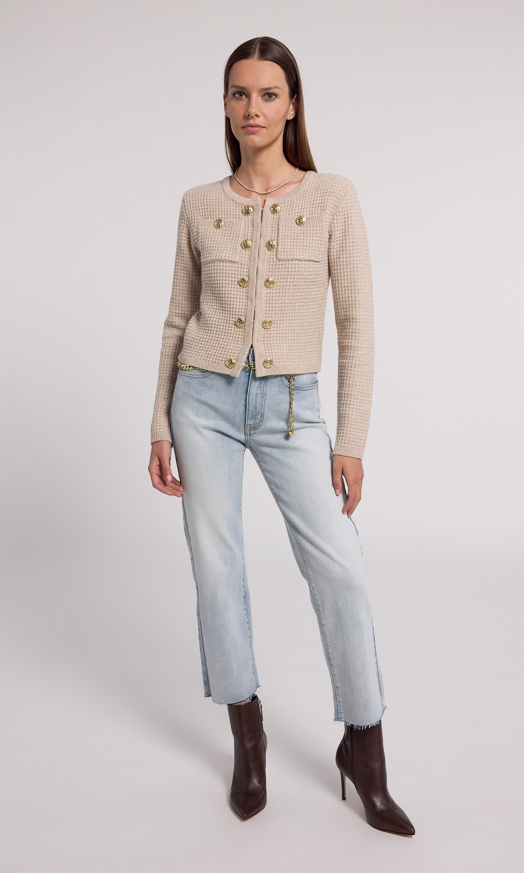 A soft knit cardigan in beige, offering comfort and elegance, suitable for various casual outfits.