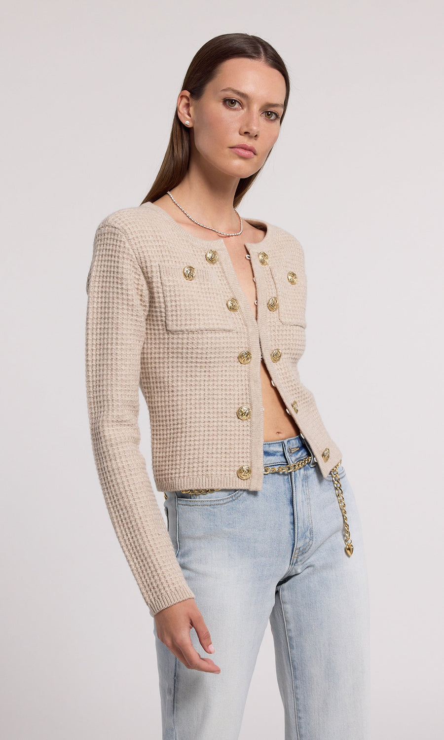 A soft knit cardigan in beige, offering comfort and elegance, suitable for various casual outfits.