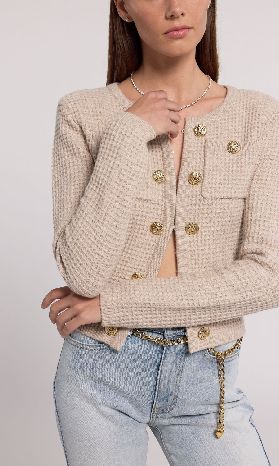 A soft knit cardigan in beige, offering comfort and elegance, suitable for various casual outfits.