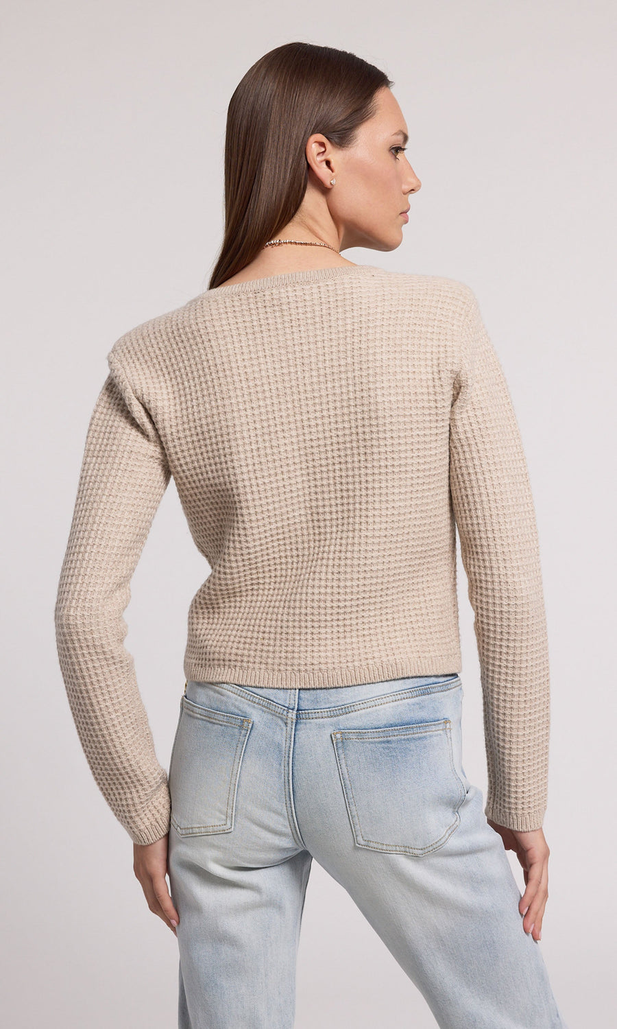 A soft knit cardigan in beige, offering comfort and elegance, suitable for various casual outfits.