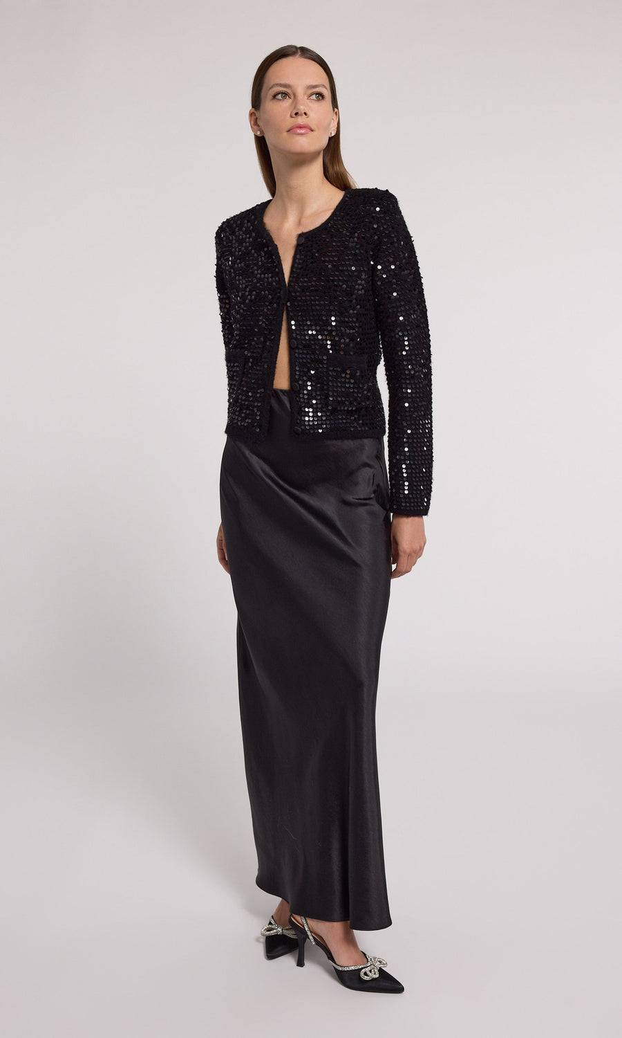 Elegant black sequin cardigan made from knit fabric, perfect for adding a touch of glamour to any outfit.