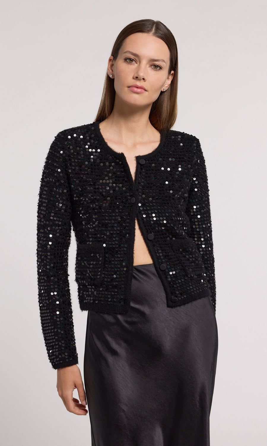 Elegant black sequin cardigan made from knit fabric, perfect for adding a touch of glamour to any outfit.