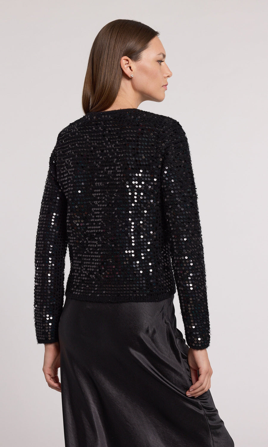 Elegant black sequin cardigan made from knit fabric, perfect for adding a touch of glamour to any outfit.