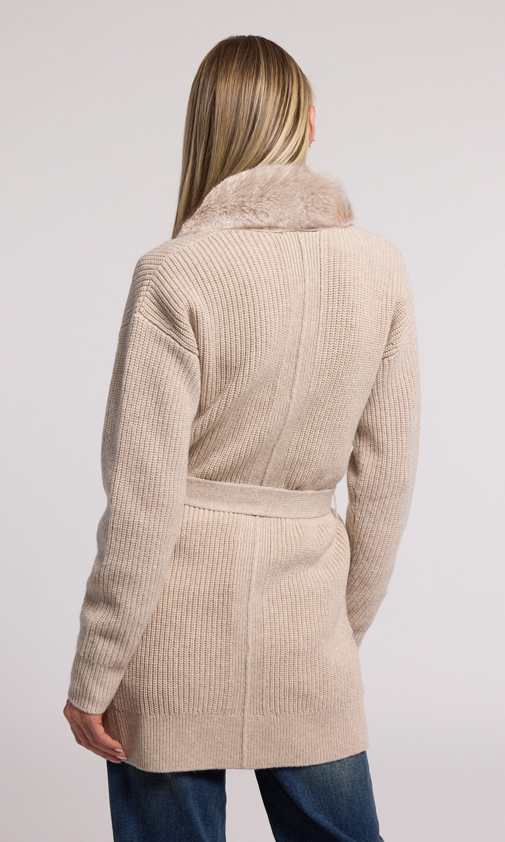 A chic wool cardigan with a plush faux fur collar, offering a blend of comfort and style for any occasion.
