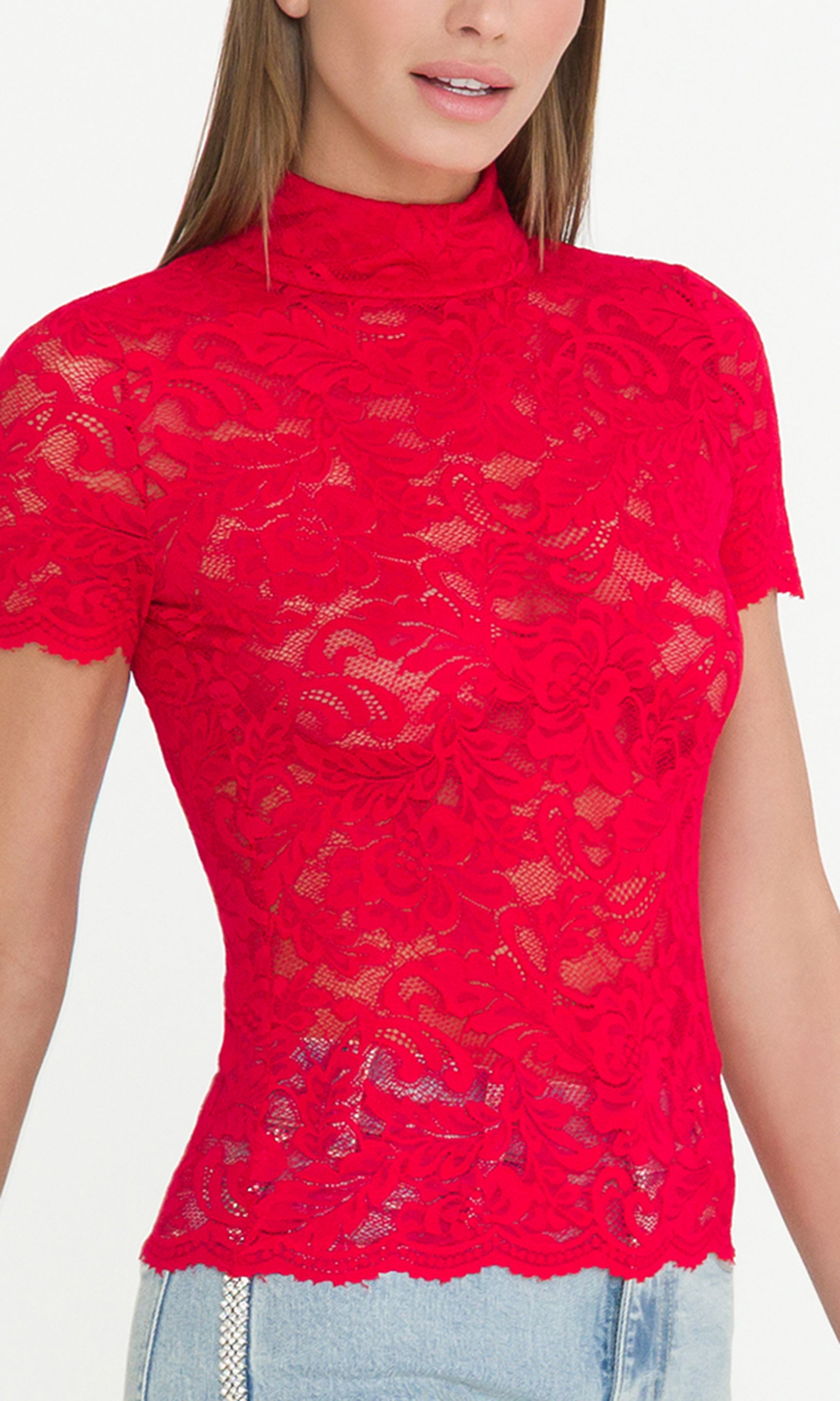 Detail image of model wearing a red lace top, showcasing the lace details.