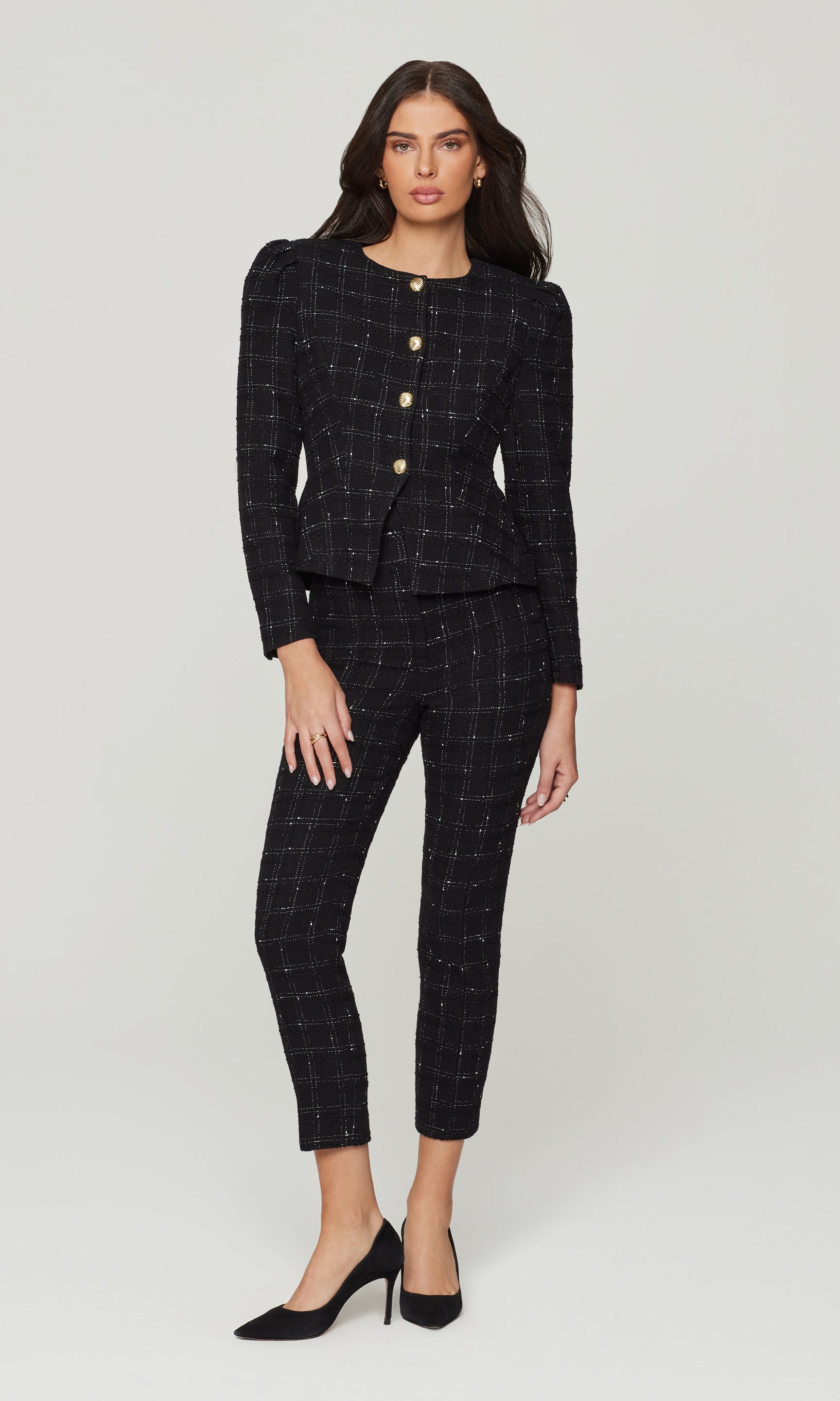 Woman wearing a black checkered suit on a white background