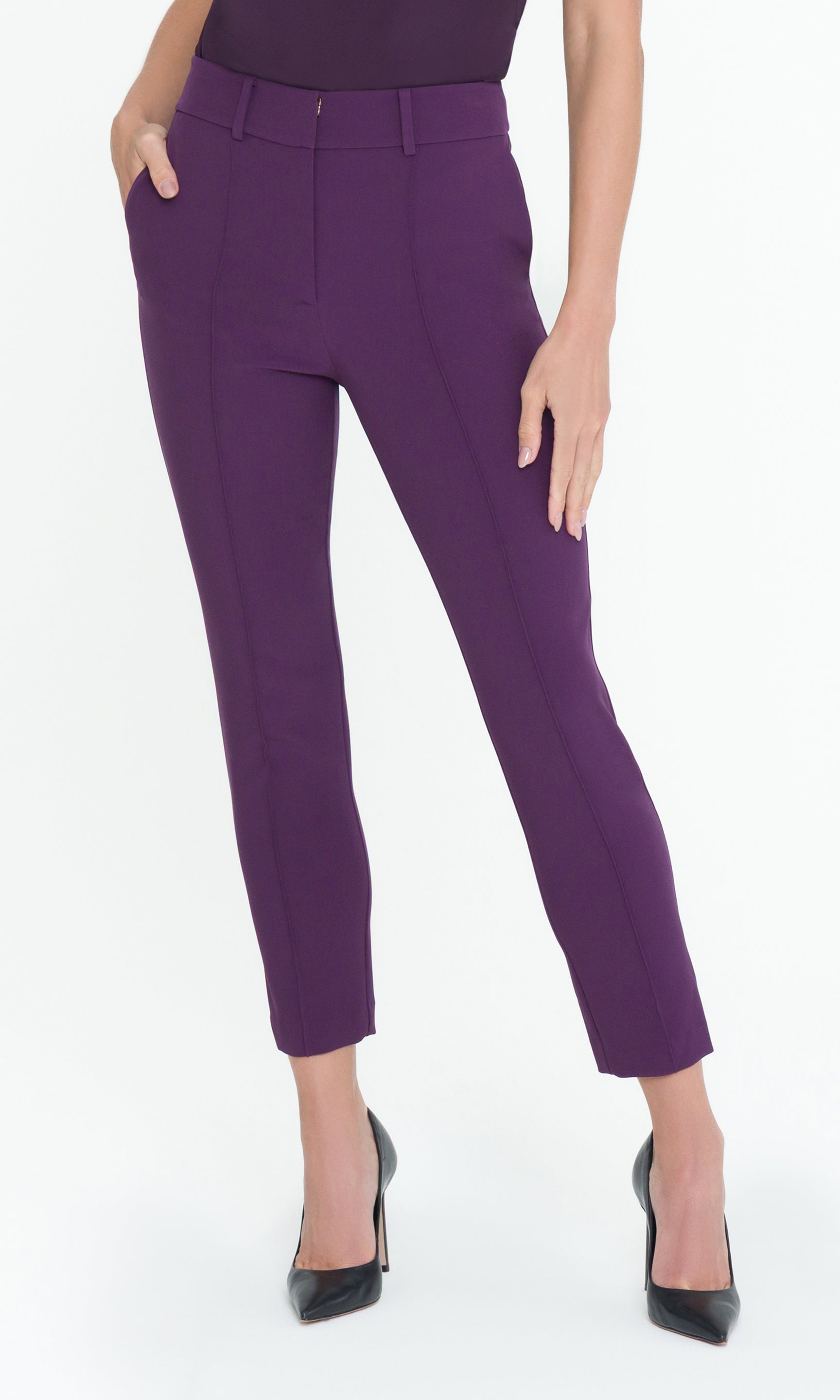 Front view of model wearing purple pants with a matching top on a white background