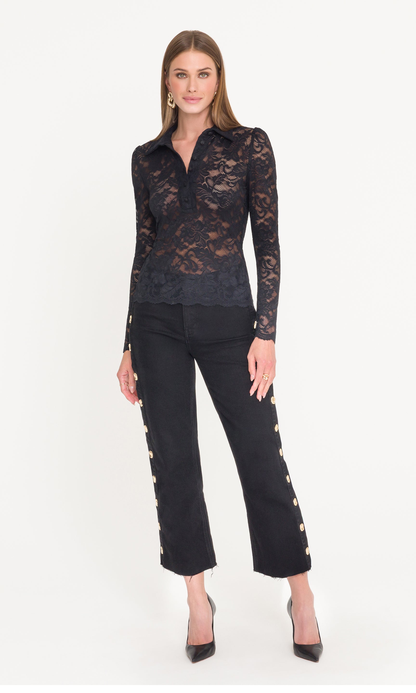 Full body image of model wearing a black lace top and black jeans