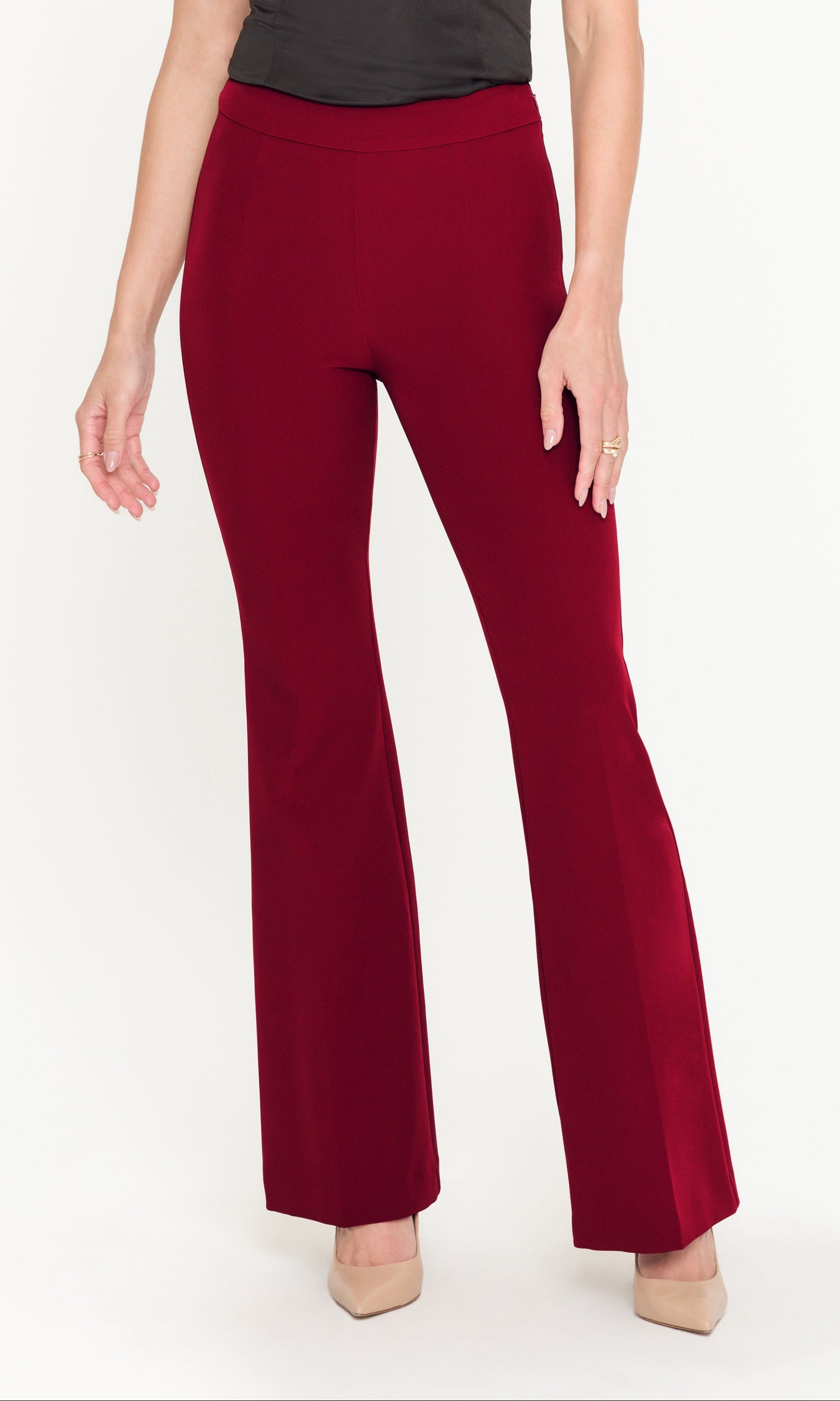 Red flared pants worn by a person on a white background