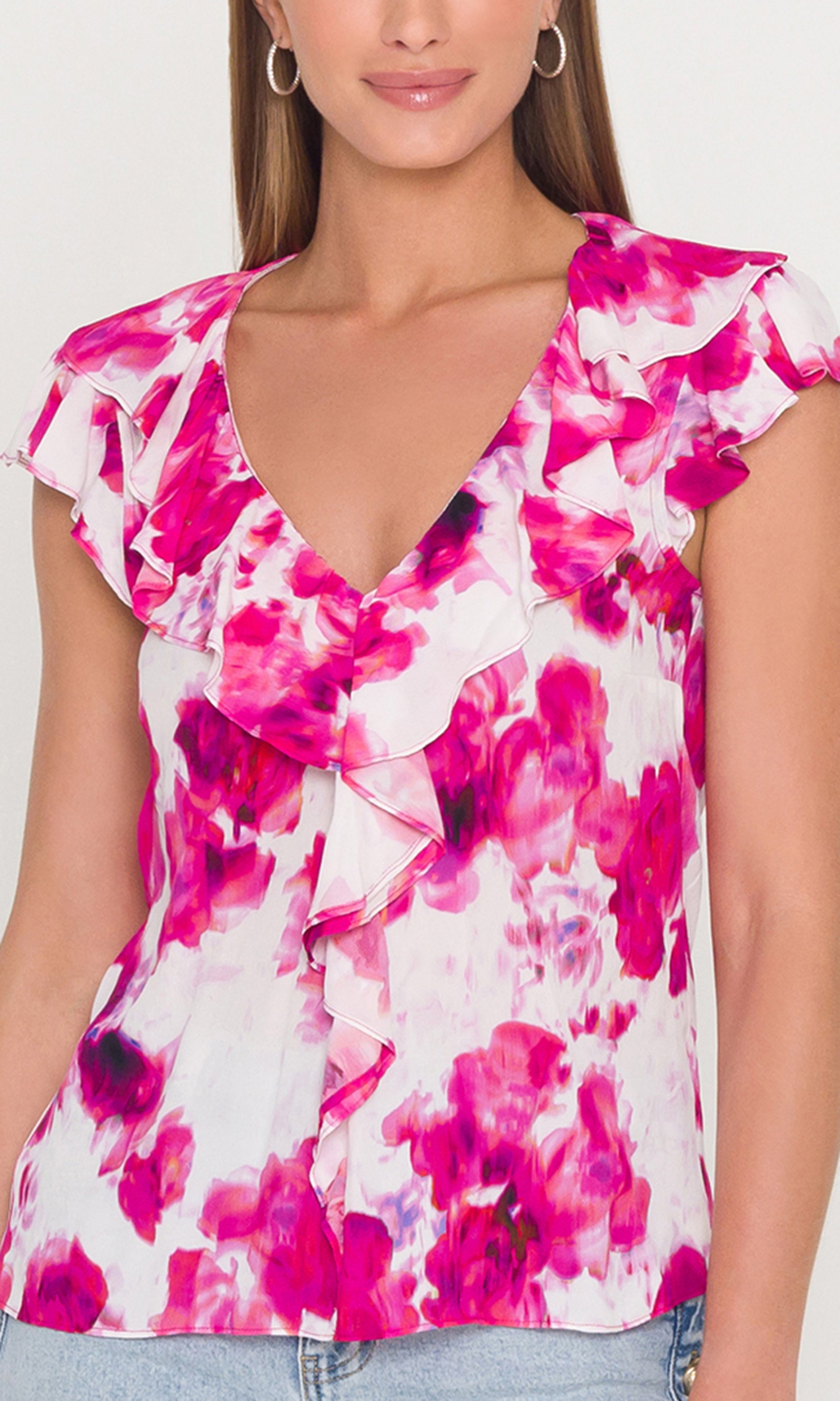 Close-up woman wearing a floral blouse with pink and white colors.
