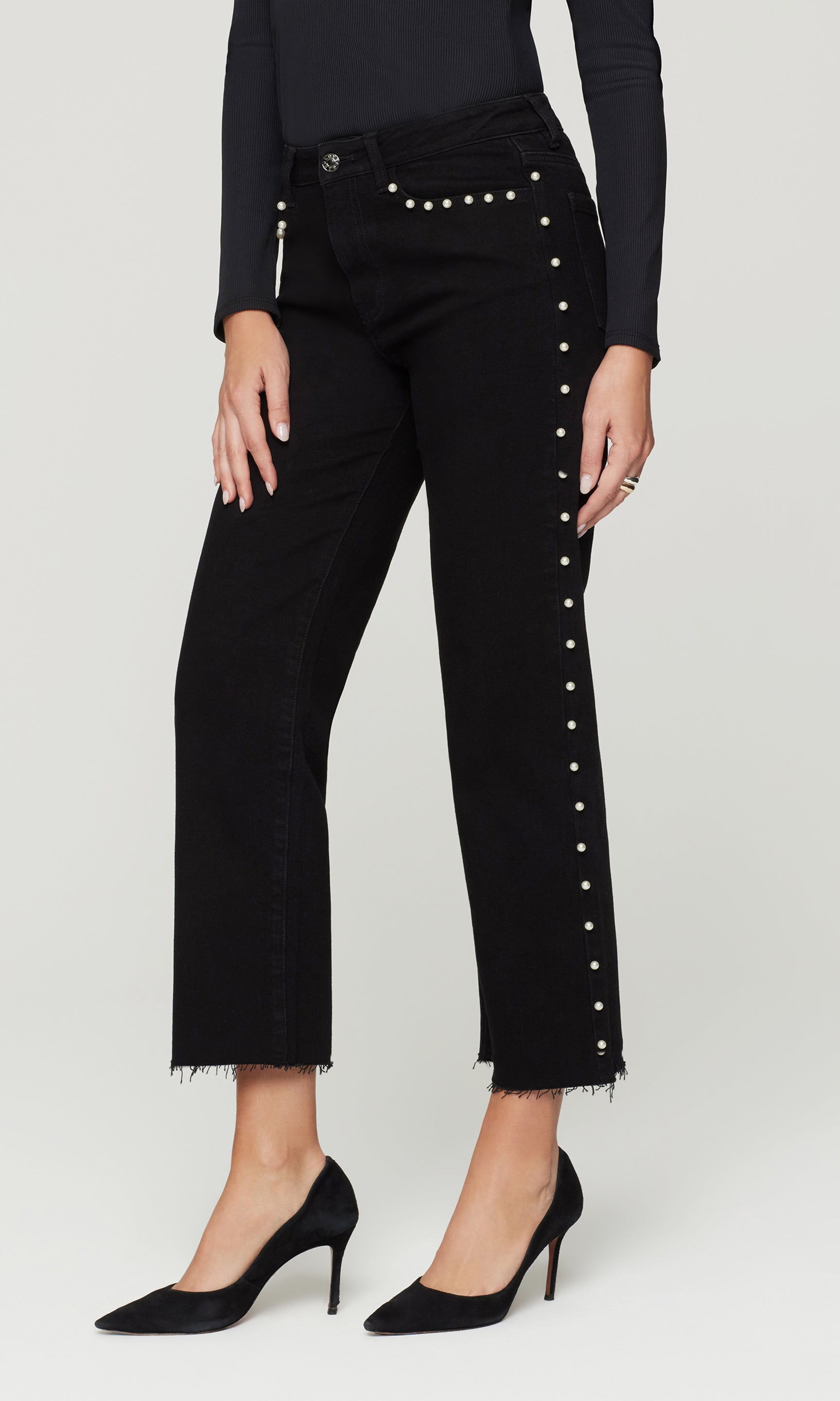 Black pants with decorative studs on a white background