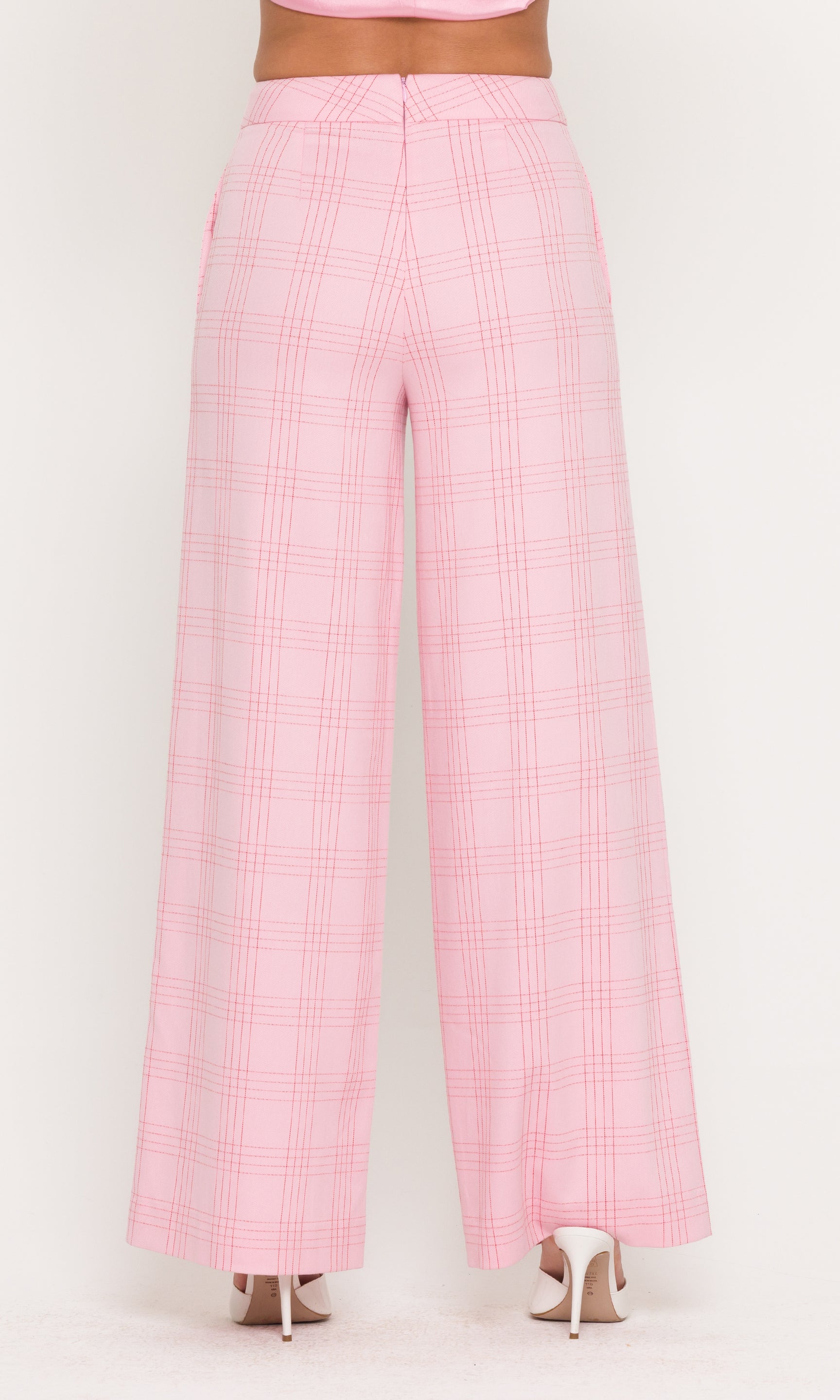 Back view of pink checkered pants on a white background